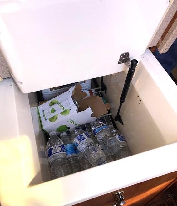 Open cooler on Hunter Vision 32 yacht with water bottles and beverage box.