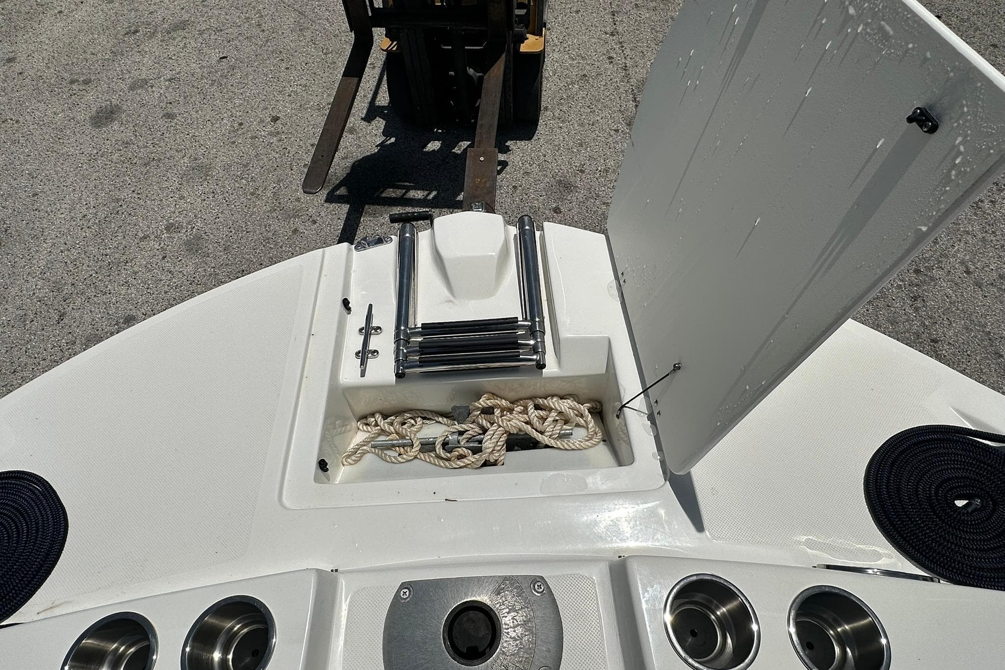 2019 Hurricane Sundeck Sport 218 OB boat deck with storage compartment open.