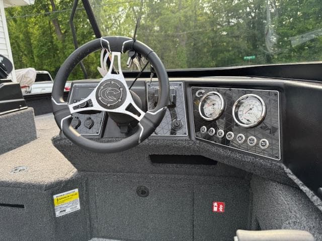 2025 Crestliner 2050 Fish Hawk dashboard with steering wheel and gauges.