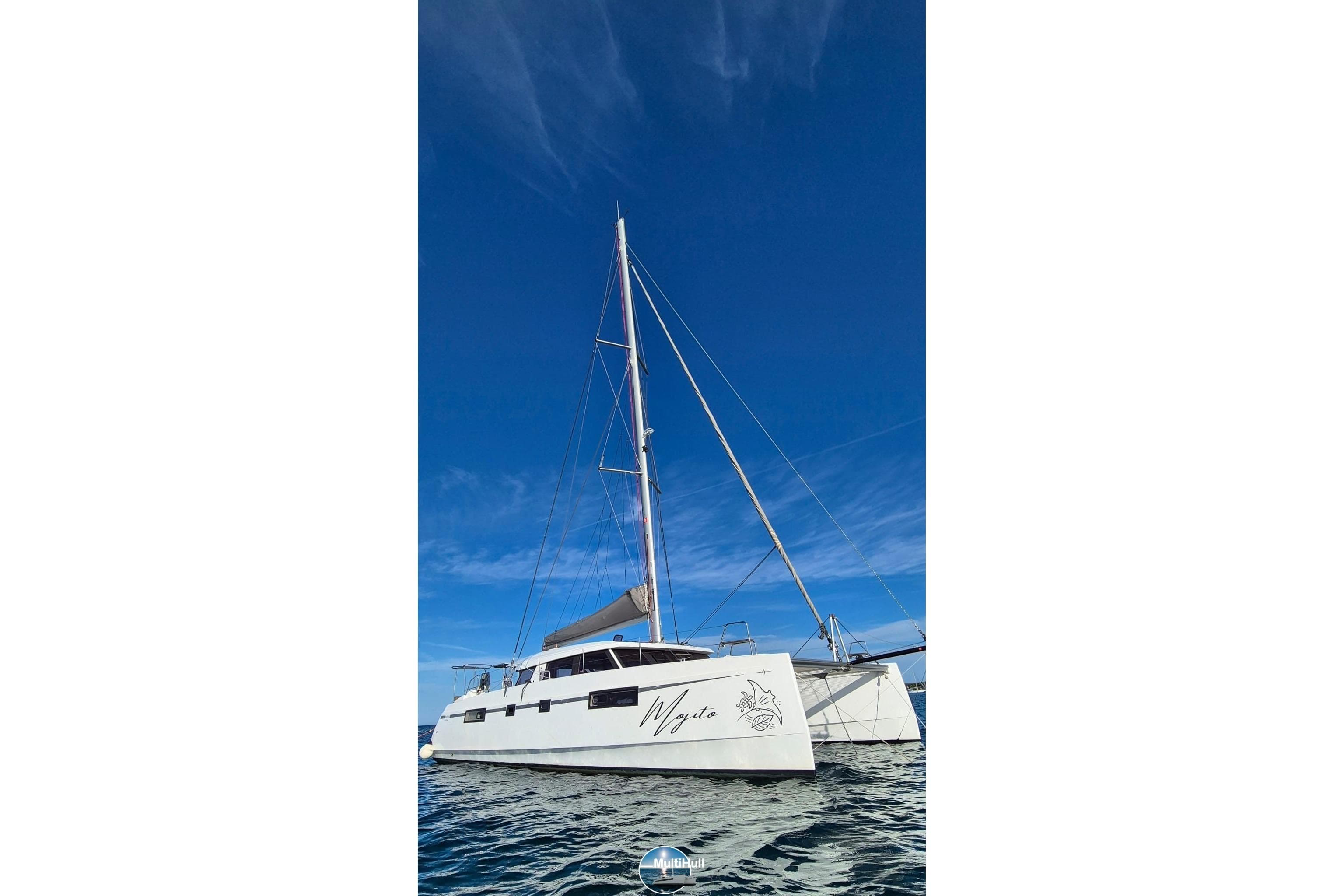2018 Nautitech 46 Open catamaran sailing on clear blue waters under a bright sky.