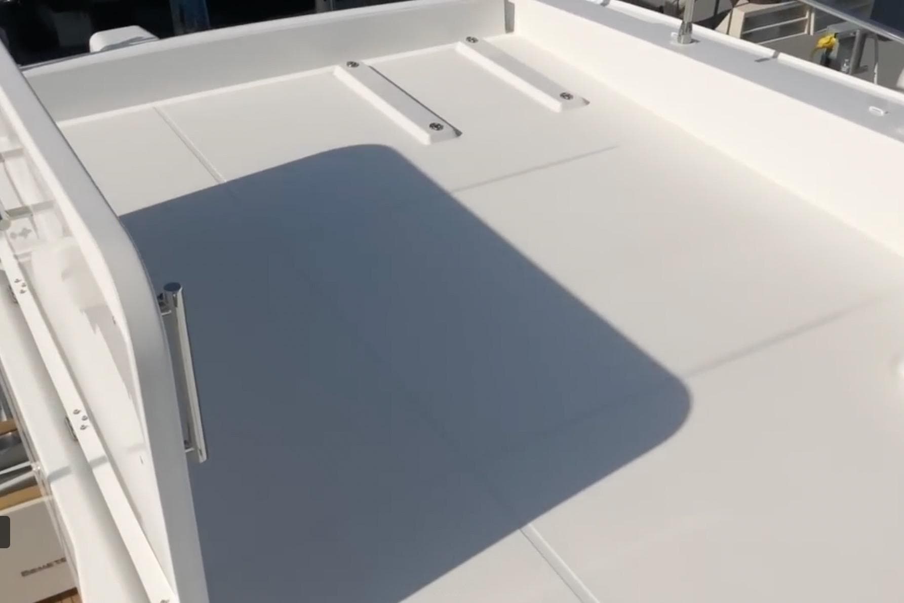 2018 Beneteau Swift Trawler 50 deck, featuring sleek white surface and railing.