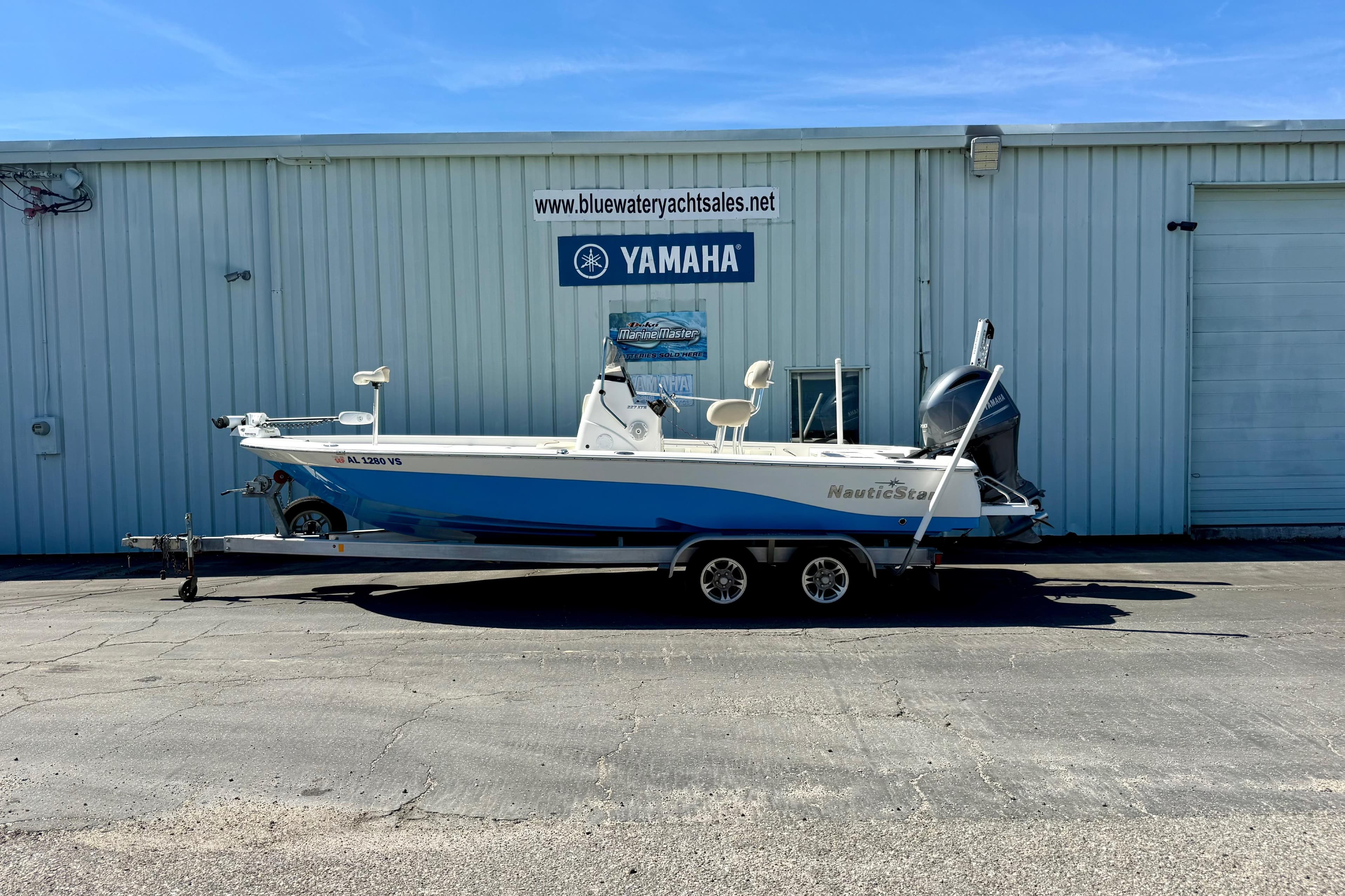 2017 NauticStar 227 XTS boat on trailer outside Yamaha dealership.