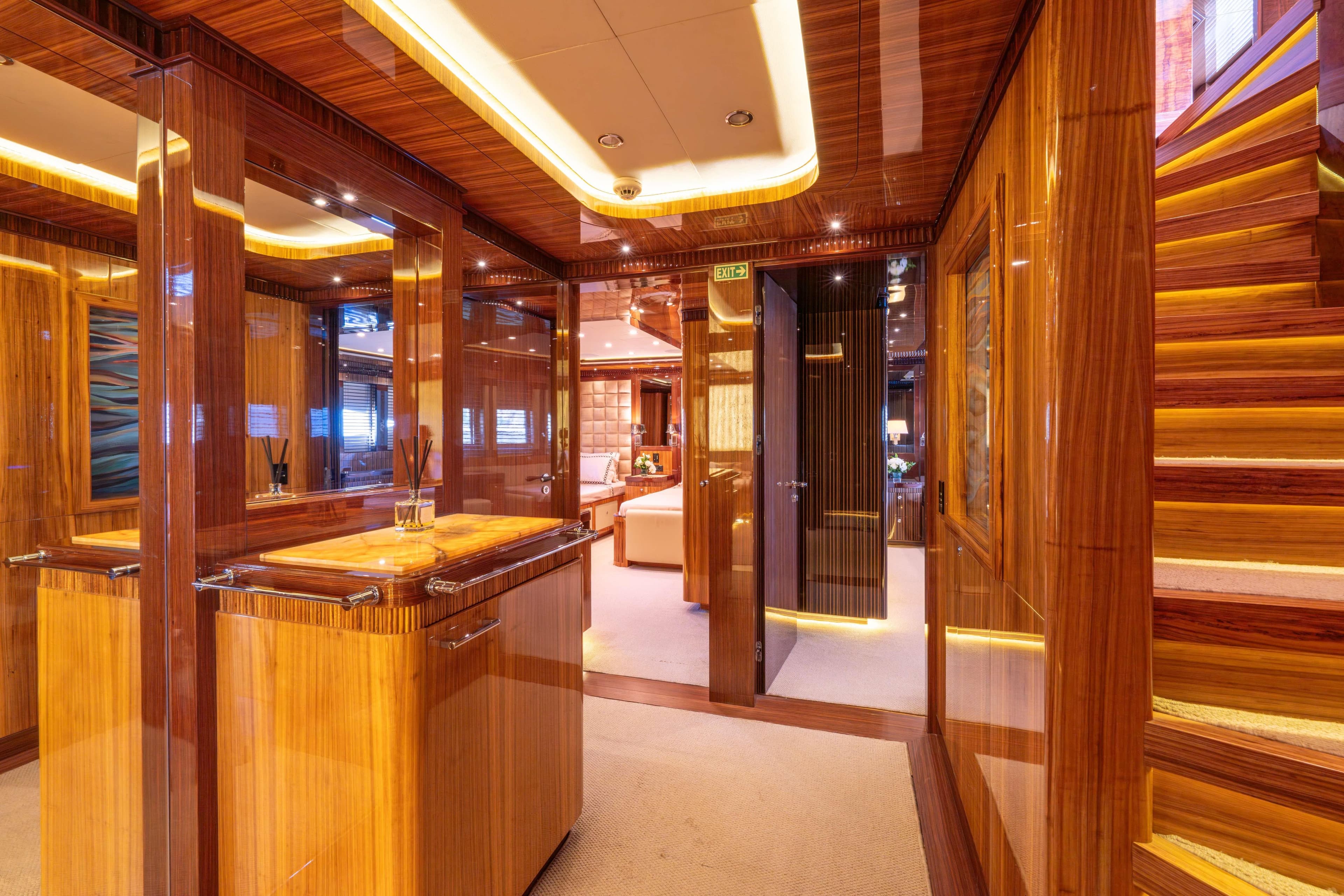 Luxurious interior of 2014 Bilgin 147 yacht with polished wood and elegant lighting.