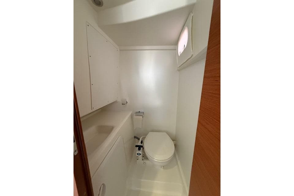 Compact bathroom in a 2015 Prestige 500 yacht, featuring a toilet and sink.