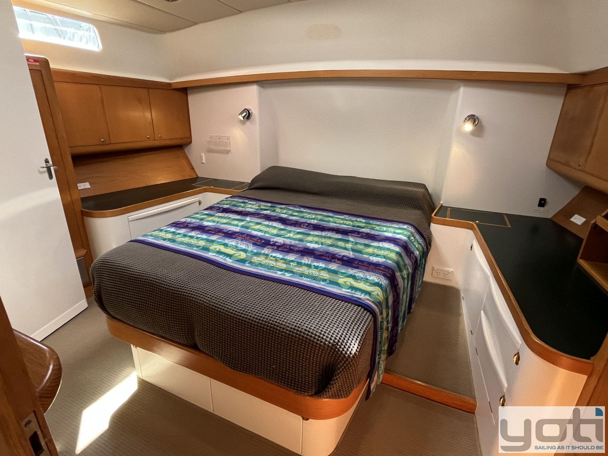 Luxurious cabin interior of 2000 Custom Mummery 51 Expedition Yacht with cozy bed.