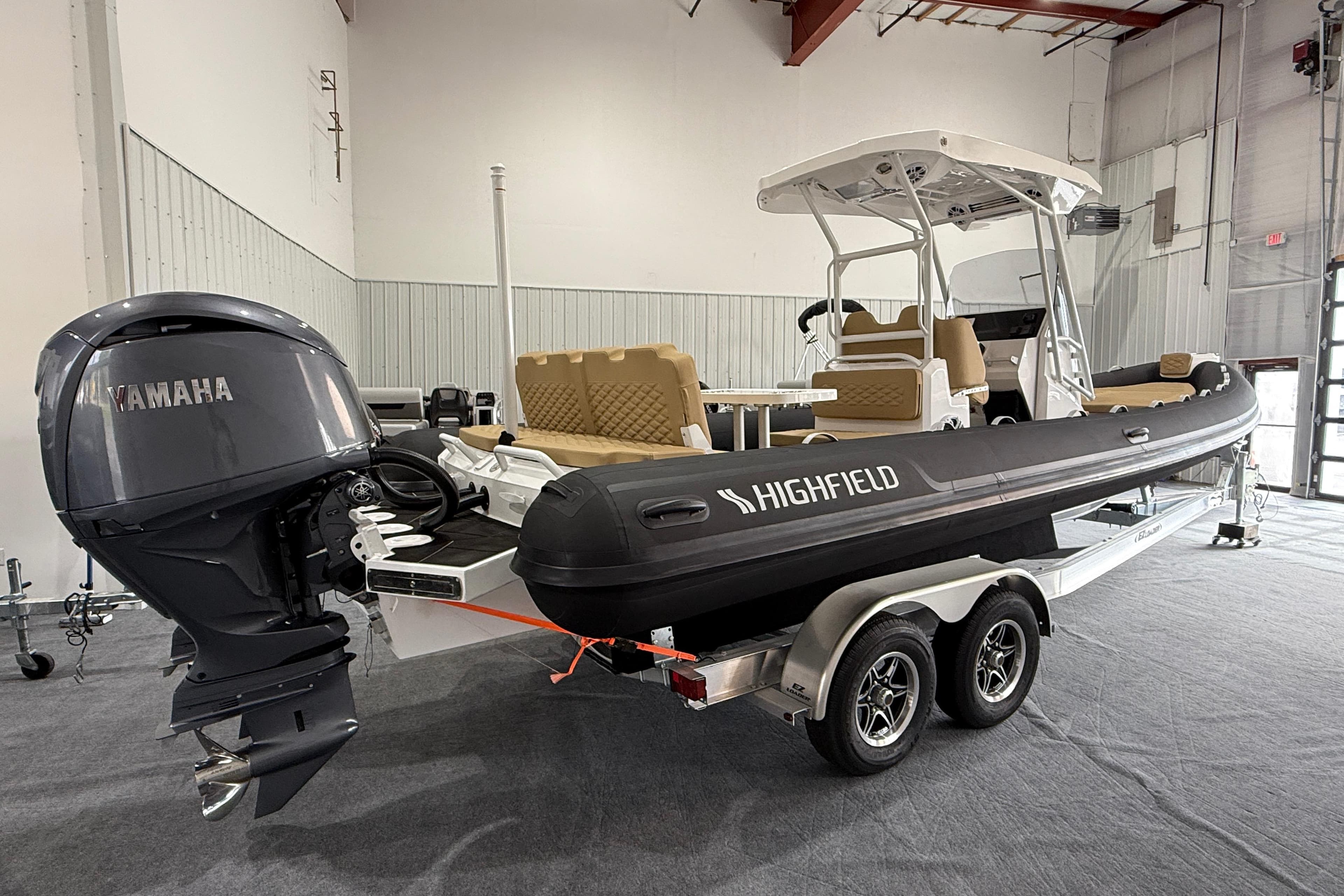 2026 Highfield Sport 800 boat with Yamaha engine on a trailer in a showroom.