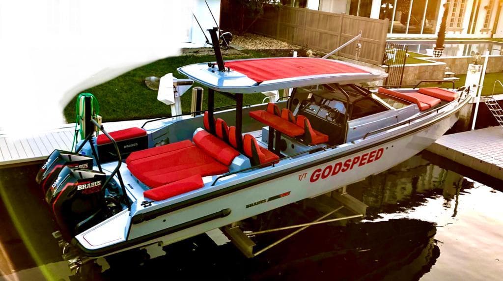 2022 Axopar Brabus Shadow 900 ST boat with red seating, docked in a marina.