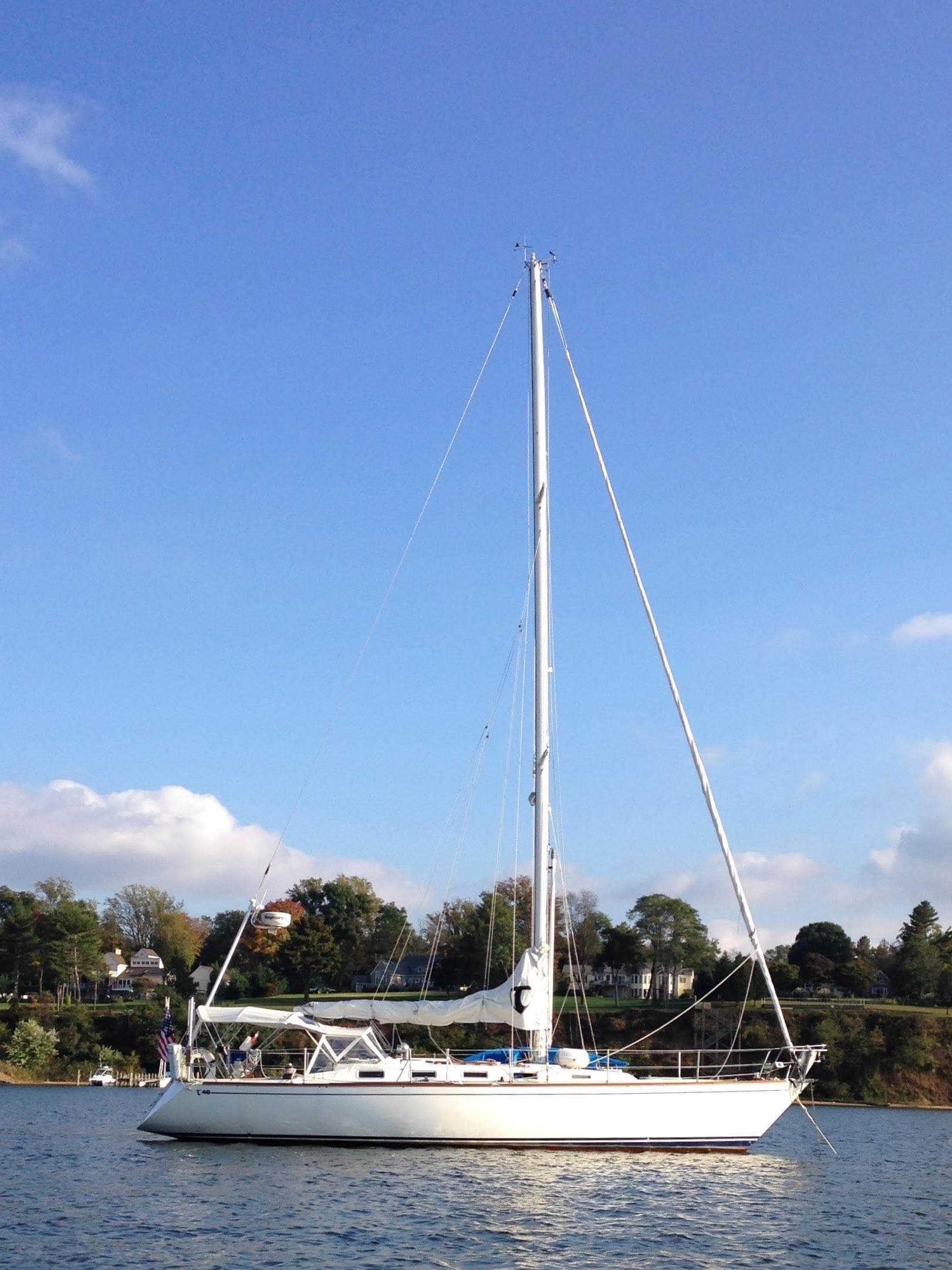 1987 Tartan 40CB sailboat on calm water under clear blue sky.