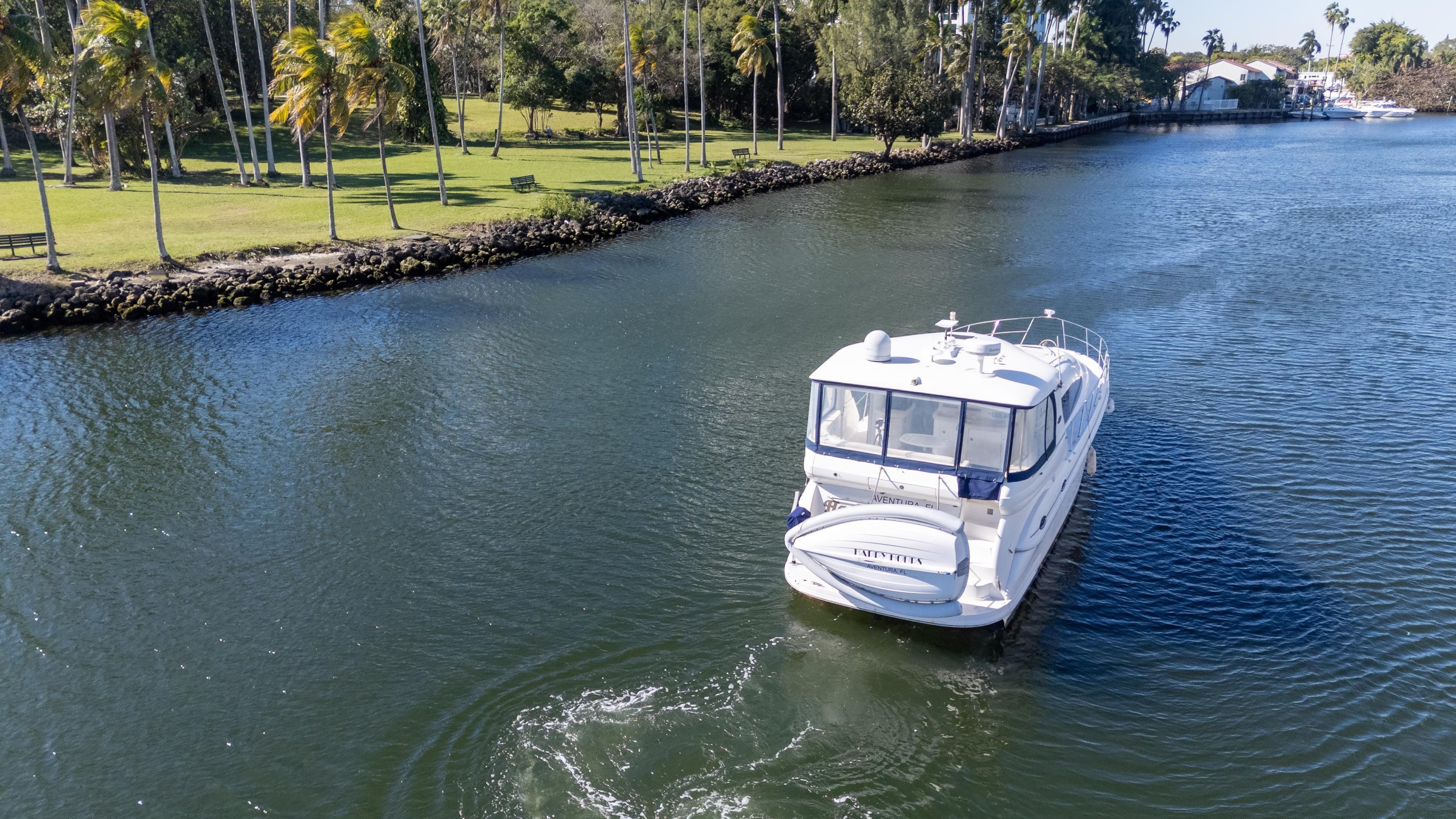 2005 Sea Ray 480 Motor Yacht cruising on a scenic river.