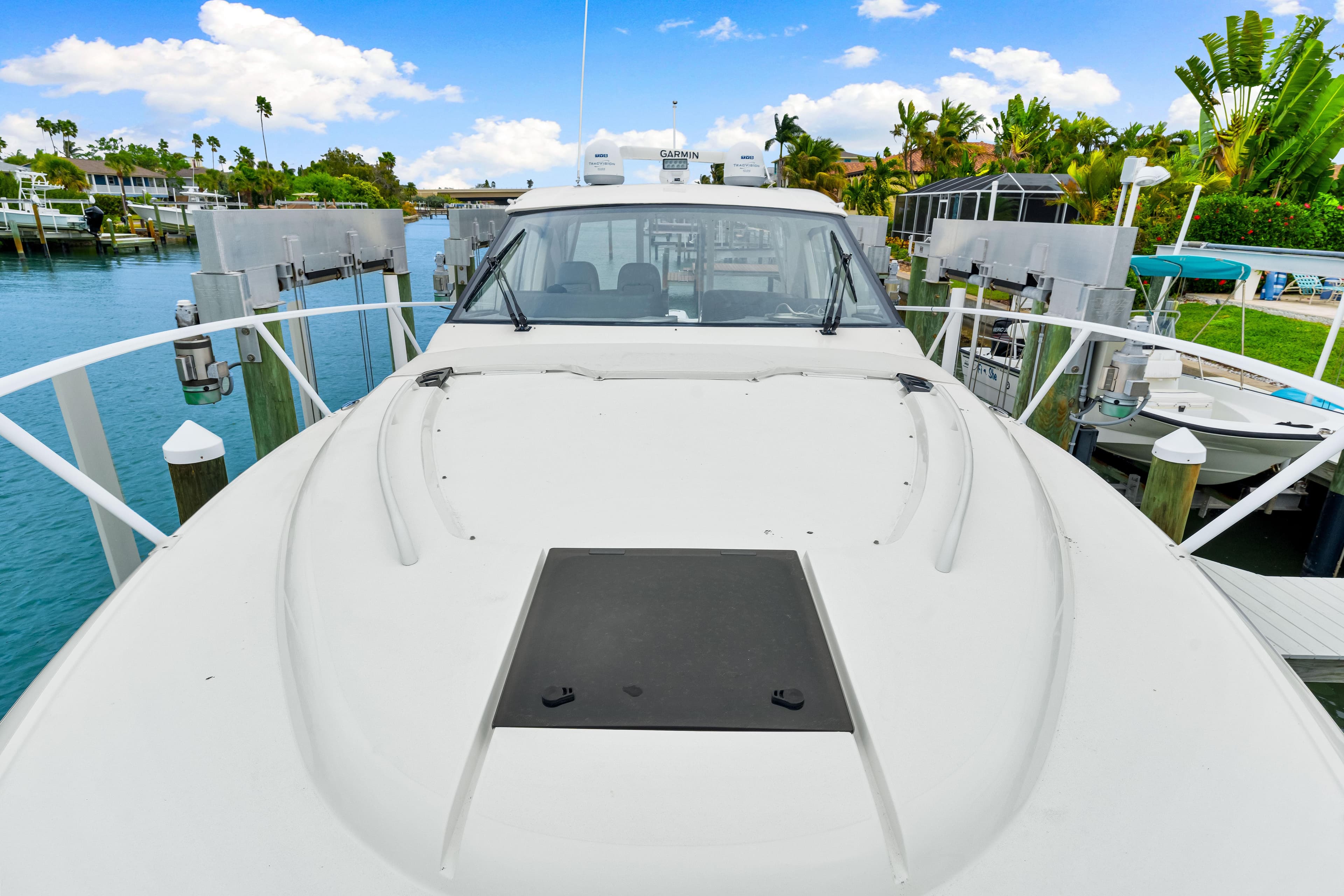 2019 Intrepid 410 Evolution yacht docked in a scenic marina setting.