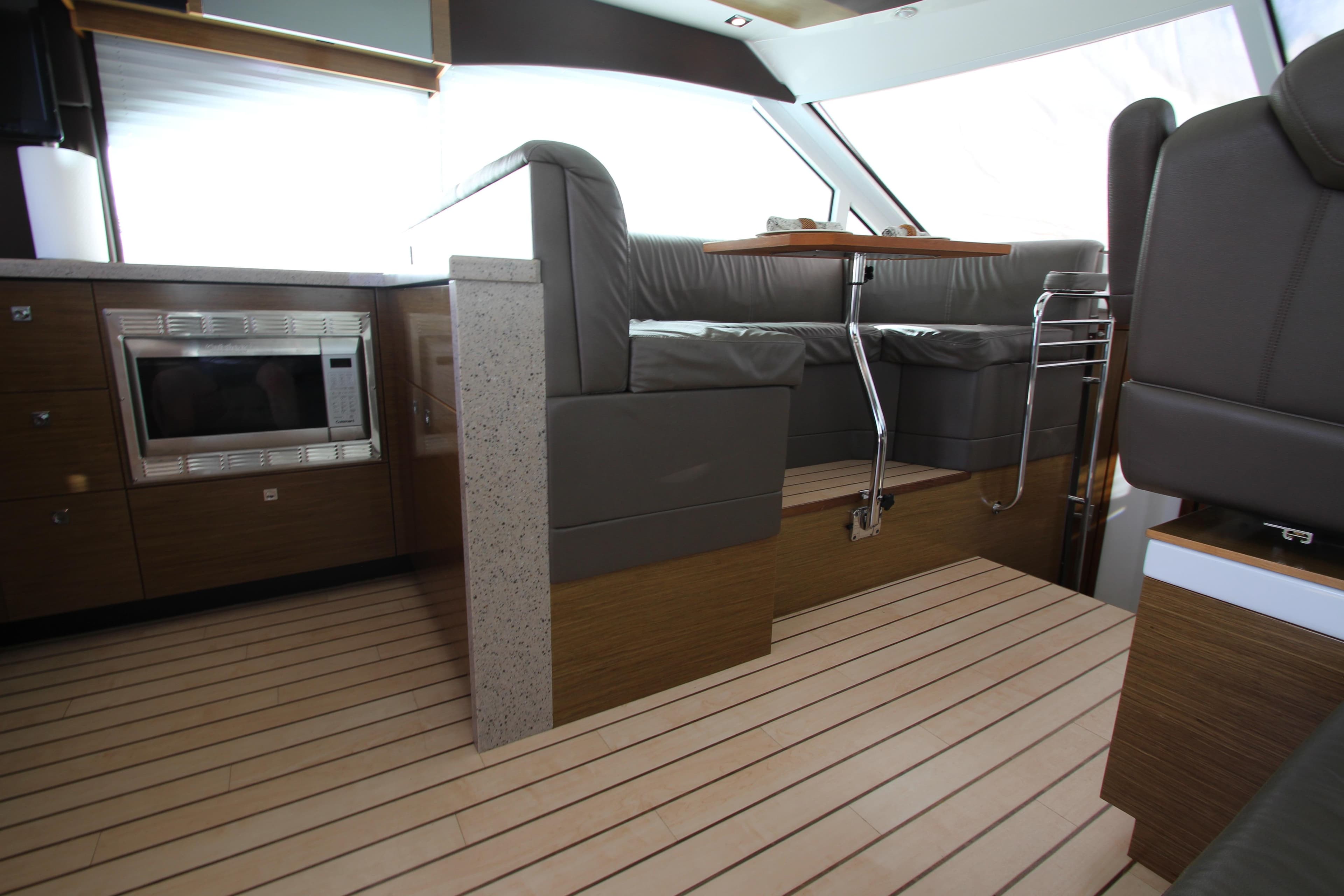 Interior of 2014 Cruisers Yachts 45 Cantius with modern seating and kitchen area.