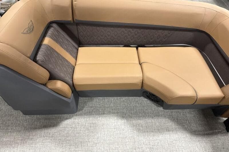 Luxurious seating on 2026 Bennington 22 M Quad Bench pontoon boat, featuring tan and gray upholstery.
