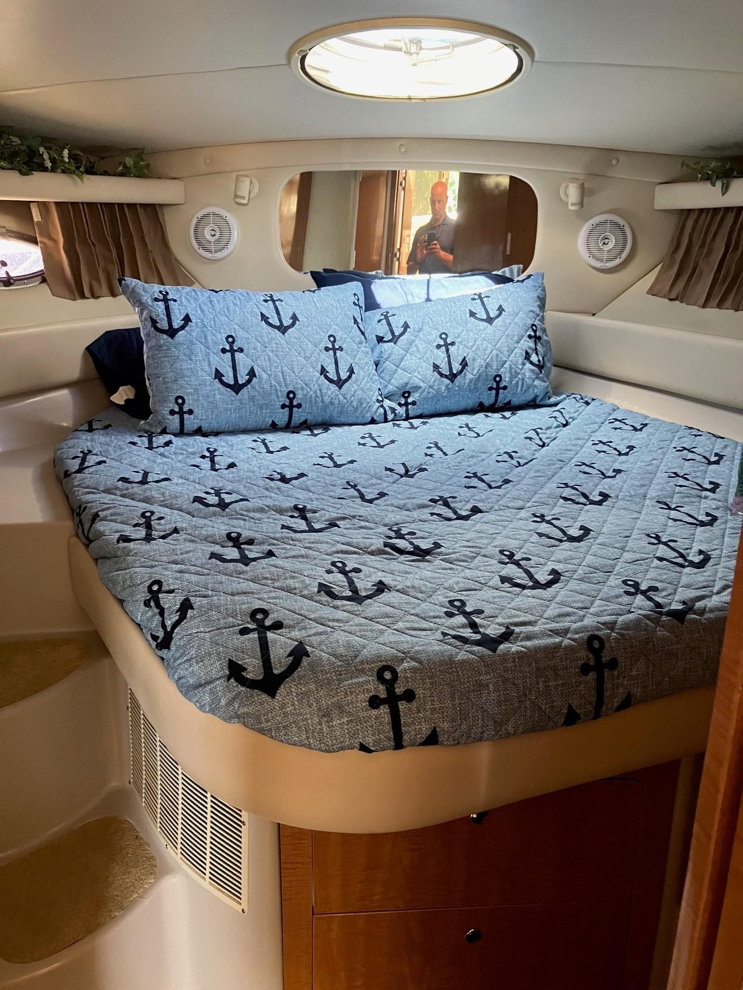 2002 Regal Commodore 3880 cabin with anchor-themed bedding and circular skylight.
