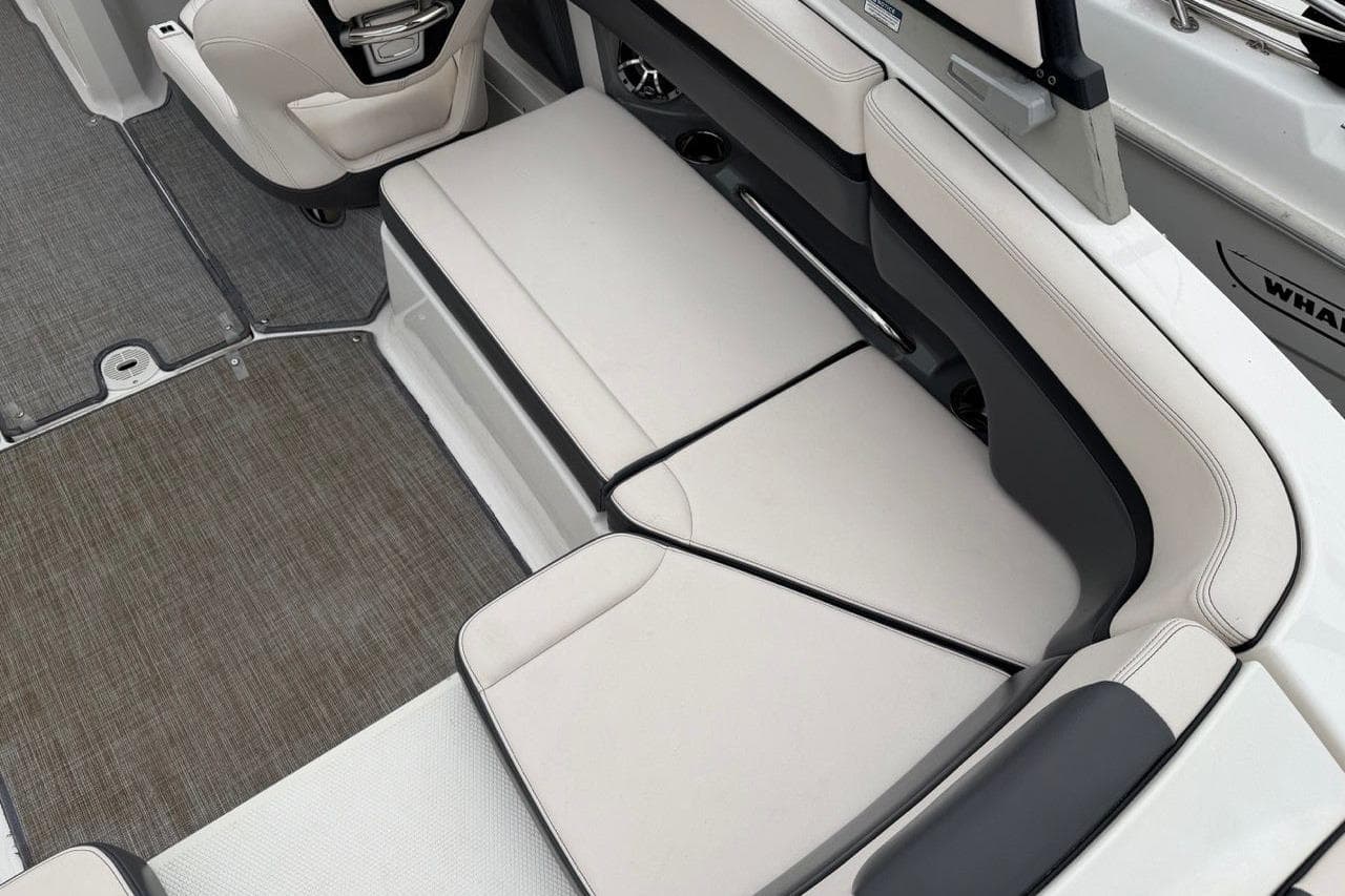 2018 Chaparral Vortex 223 VRX boat interior with beige seating and gray flooring.