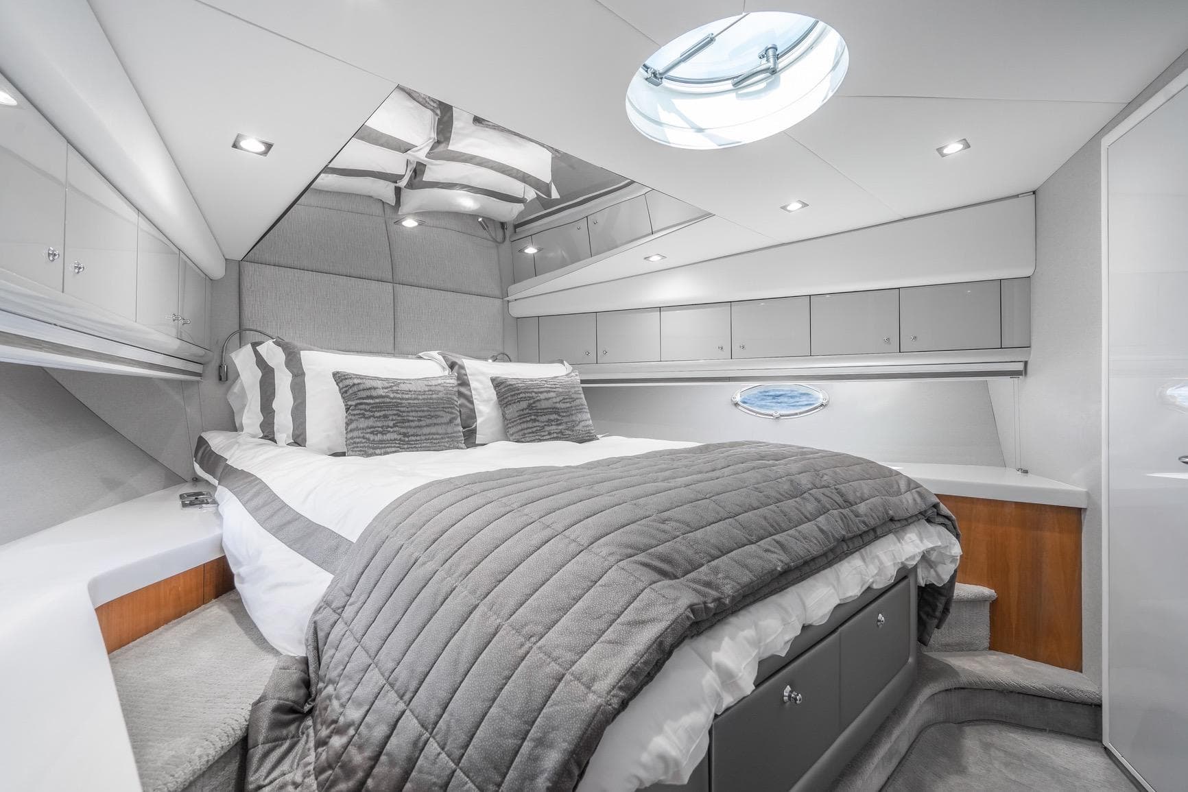 Luxurious bedroom interior of 2021 Sunseeker Predator 68 yacht, featuring modern design and elegant decor.