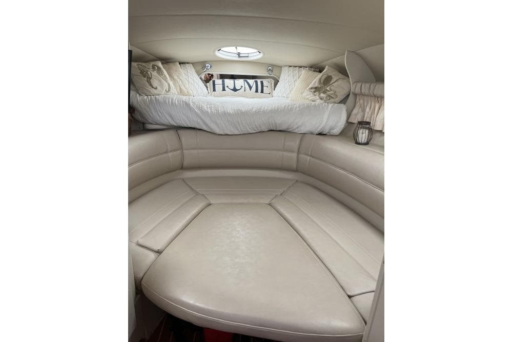 Interior of 1996 Cruisers Yachts 3175 Rogue with cozy seating and nautical decor.