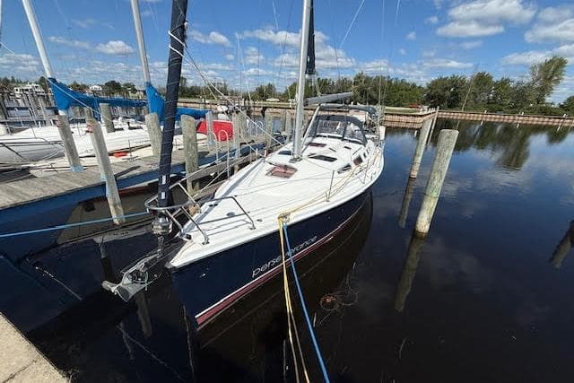 Hunter 38 sailboat from 2005 docked at a marina under a clear blue sky.