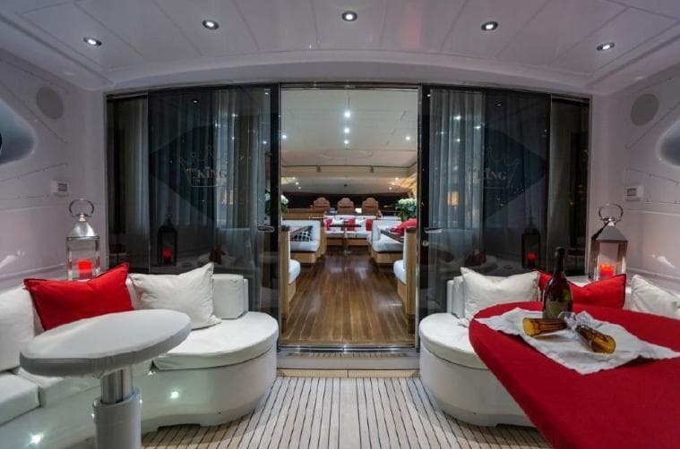 Luxurious interior of a 2004 Mangusta 108 yacht with elegant seating and ambient lighting.