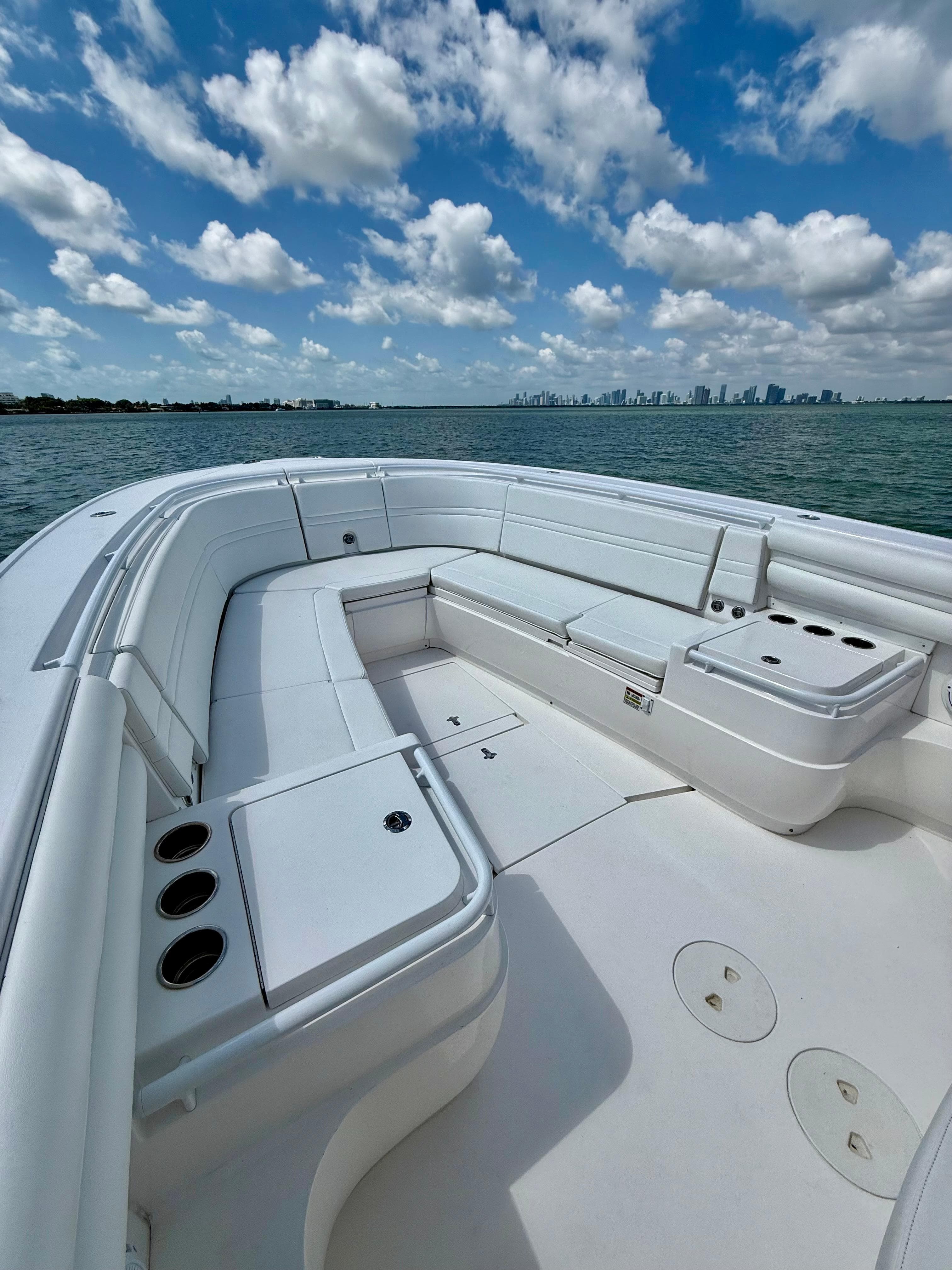 2015 Intrepid 375 Center Console boat with spacious seating, on calm waters under a partly cloudy sky.