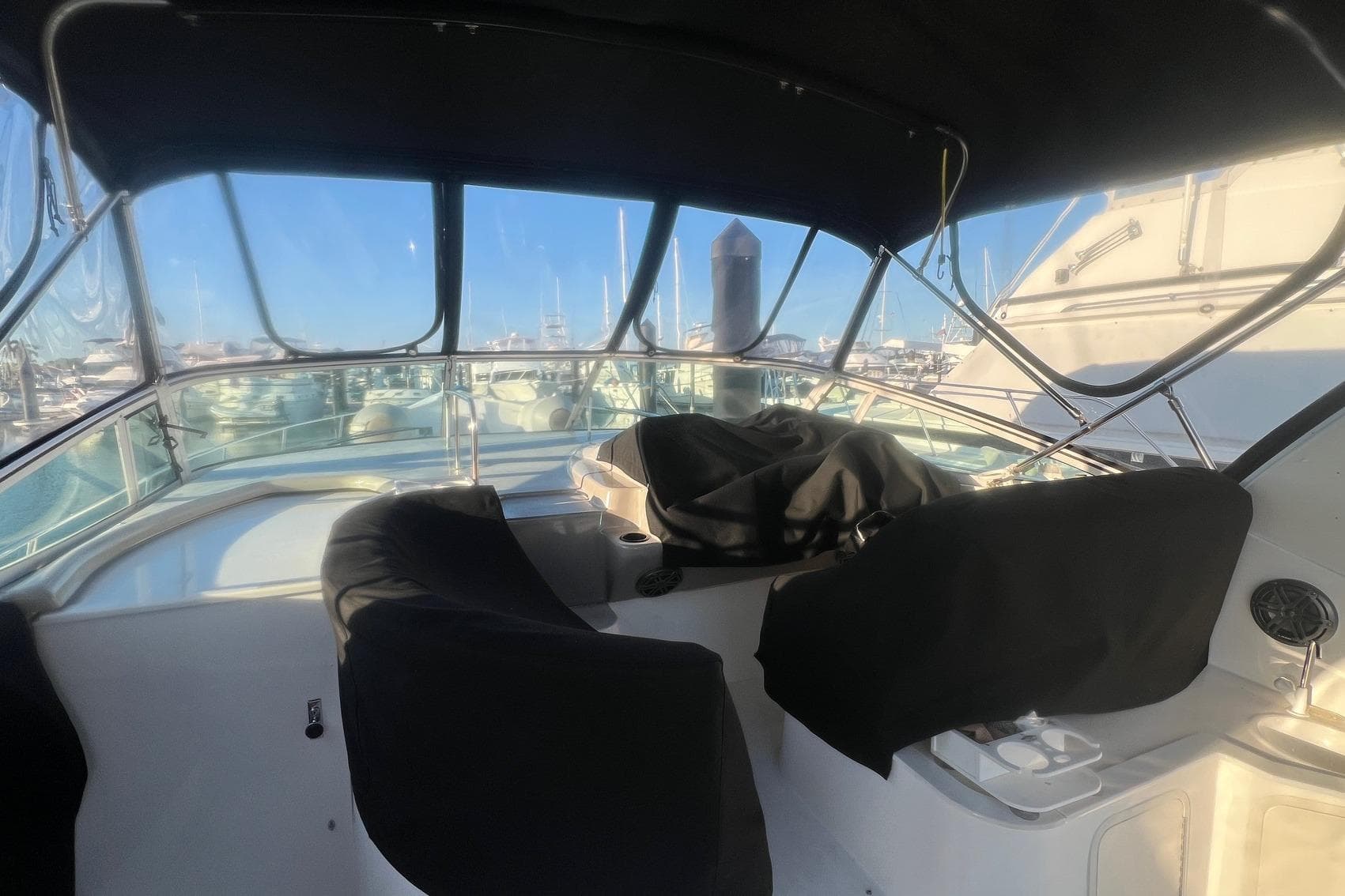 2001 Cruisers Yachts 3572 Express cockpit with covered seats and marina view.