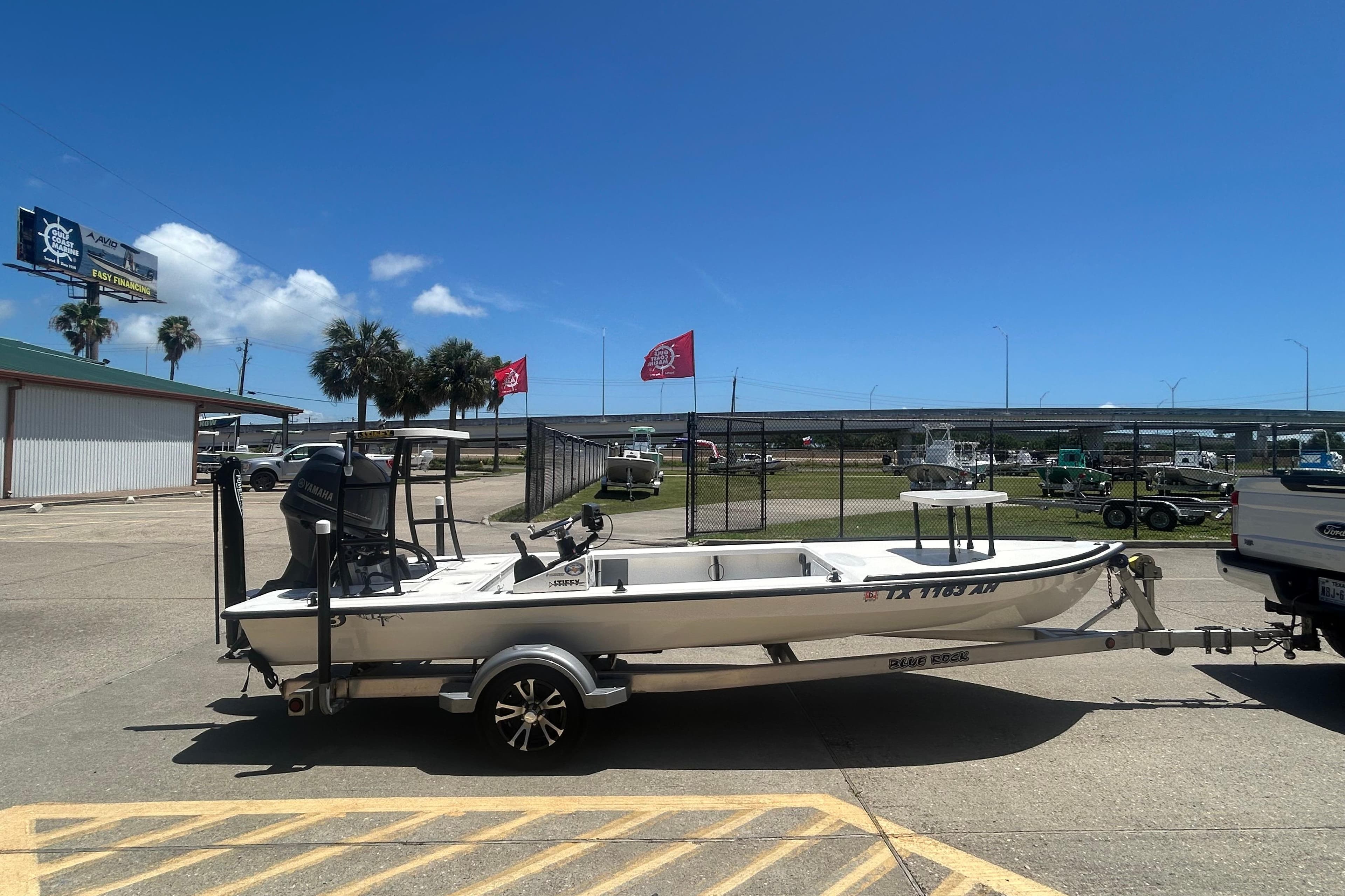 2006 Beavertail Skiffs Vengeance boat on trailer, parked outdoors under clear blue sky.