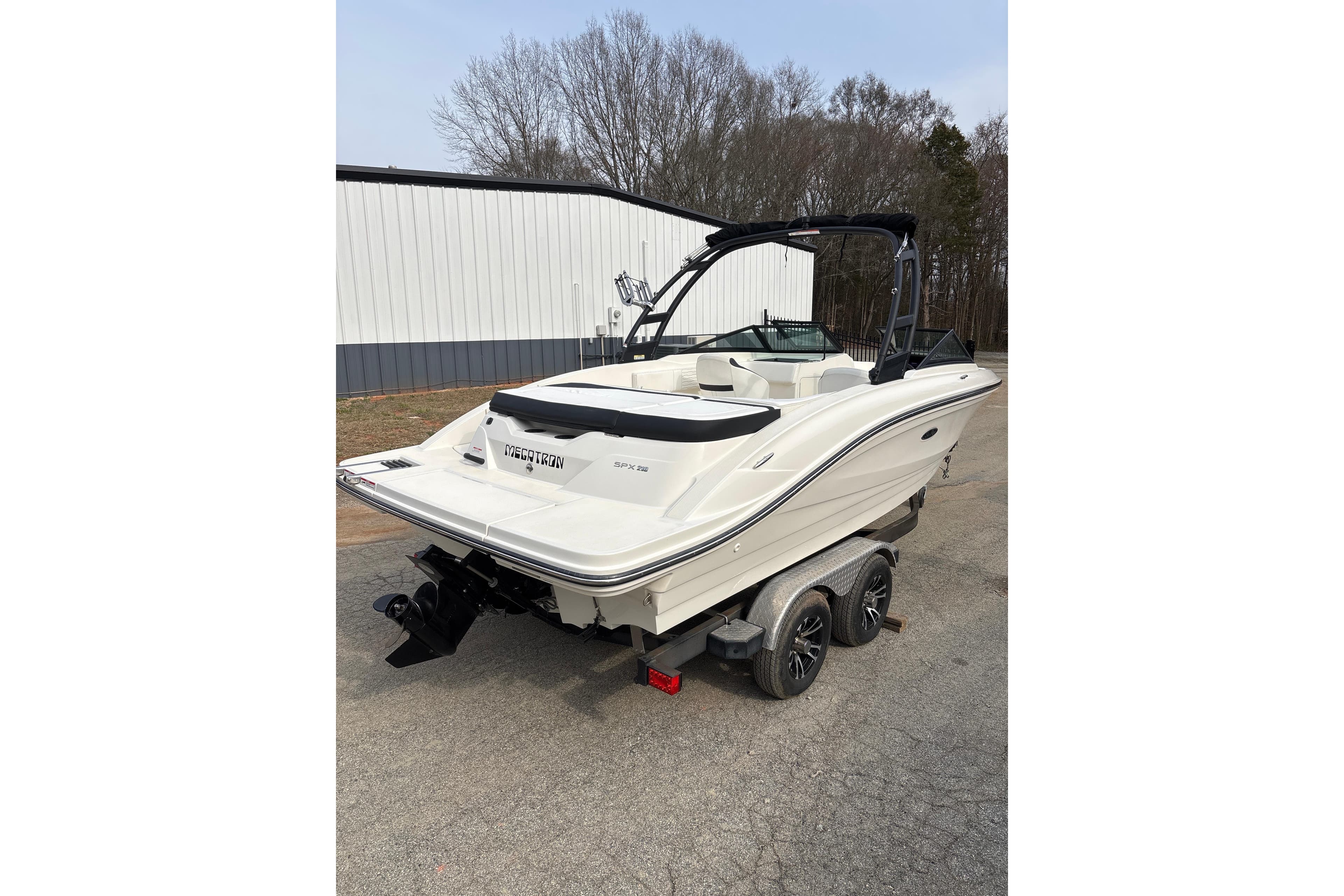 2023 Sea Ray SPX 210 boat on trailer, parked outdoors.
