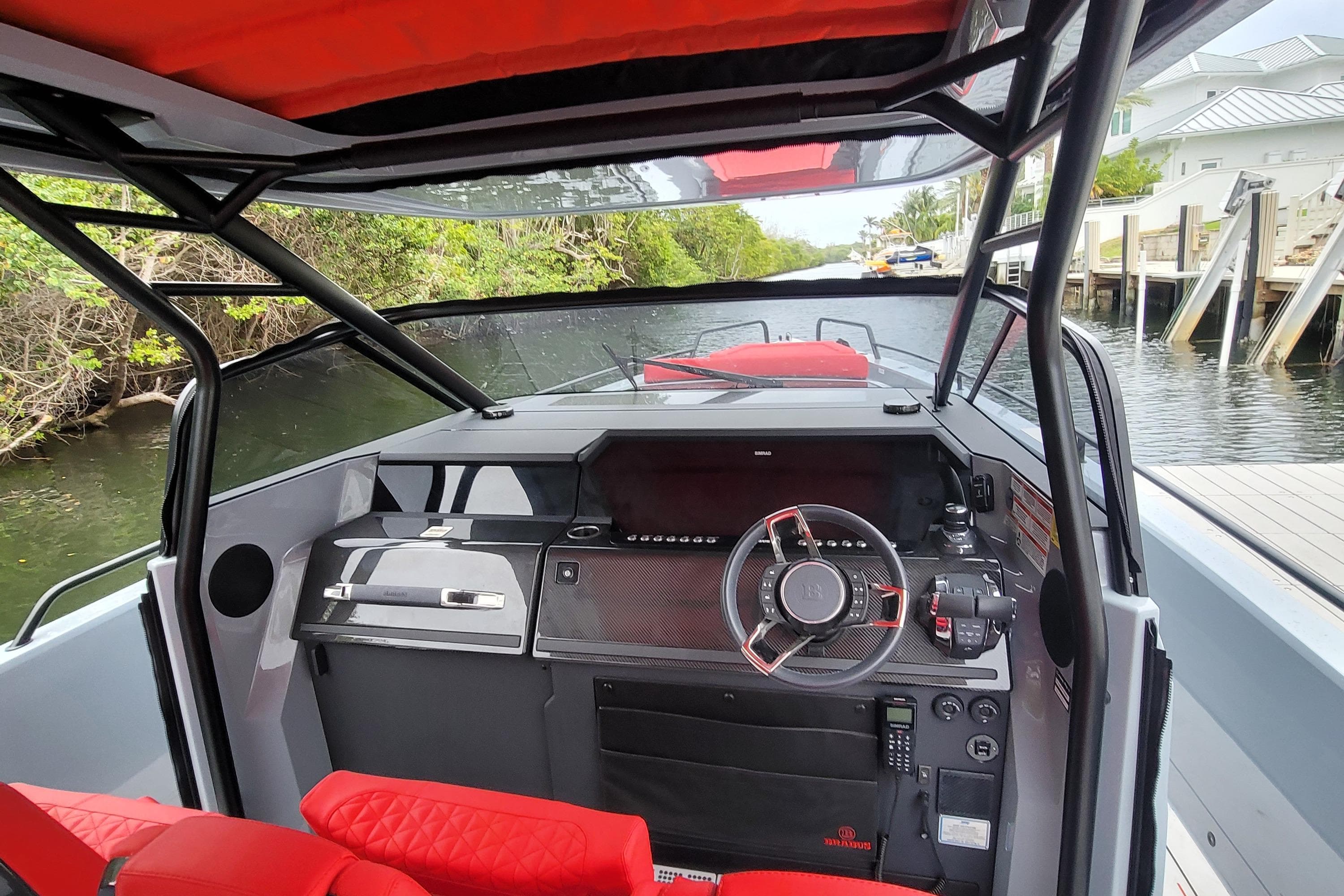 2022 Axopar Brabus Shadow 900 ST boat interior with red seating and modern dashboard.