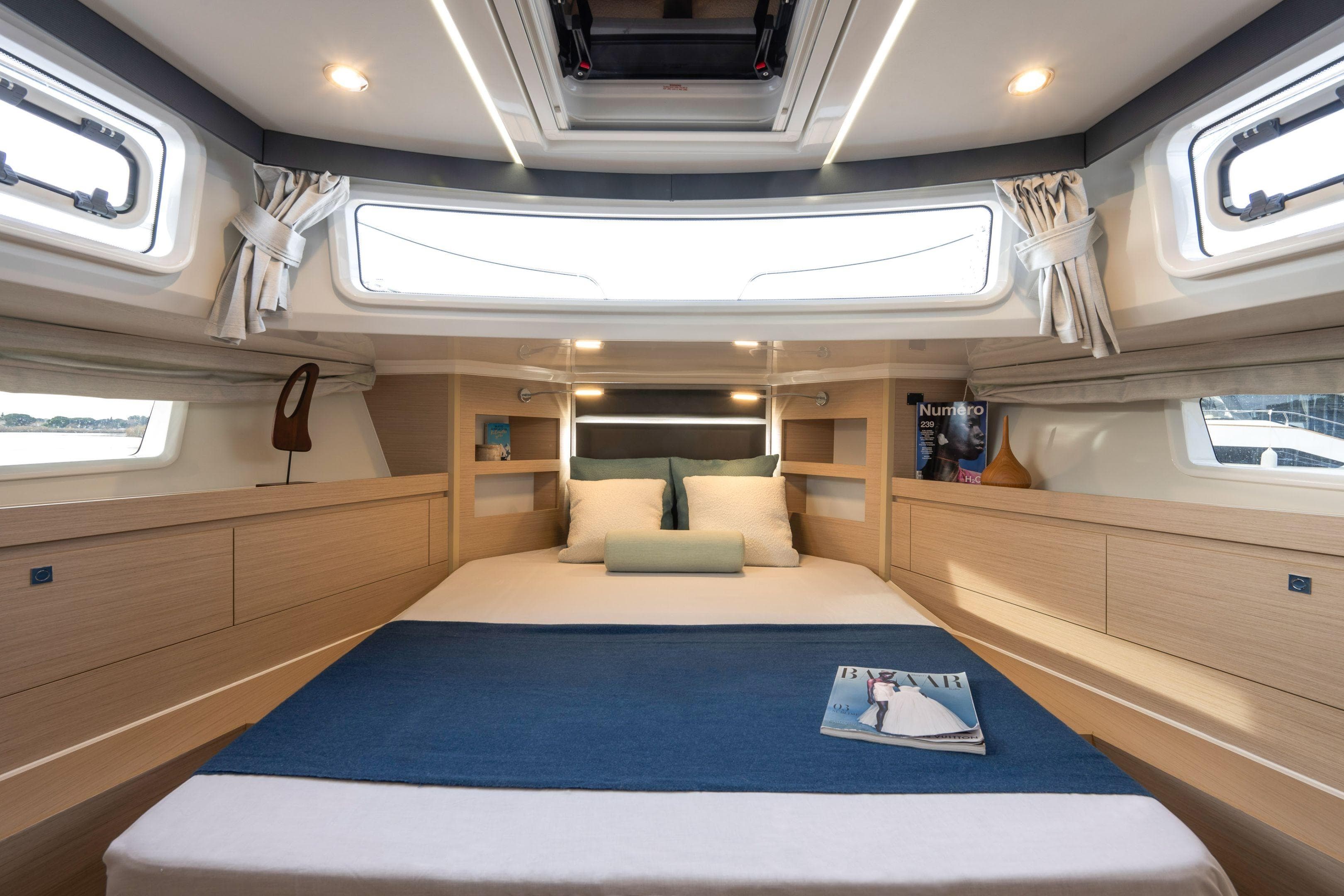 Luxurious cabin interior of 2026 Delphia D12 Fly yacht with elegant bedding and modern decor.