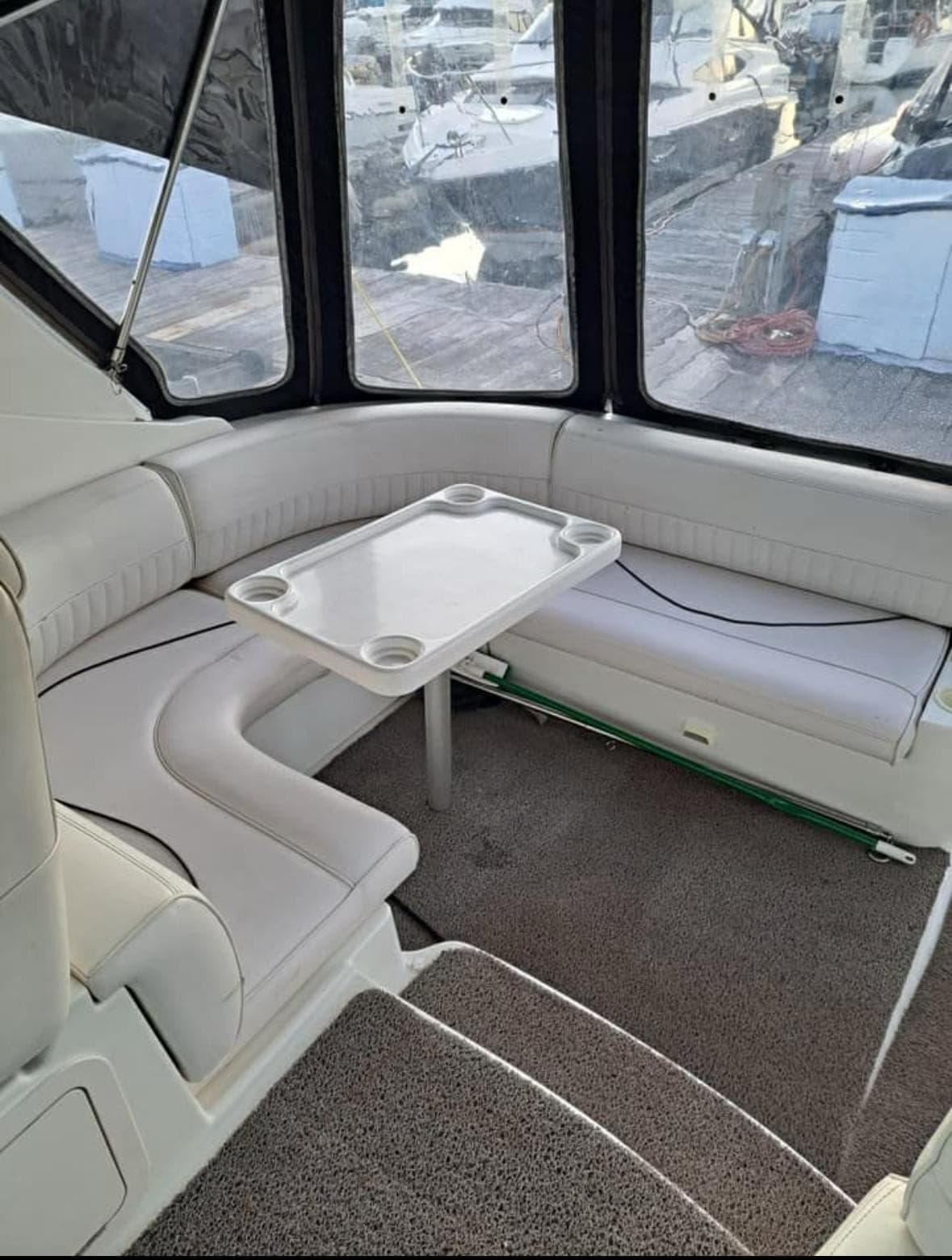 2001 Cruisers Yachts 3470 Express interior with white seating and table.