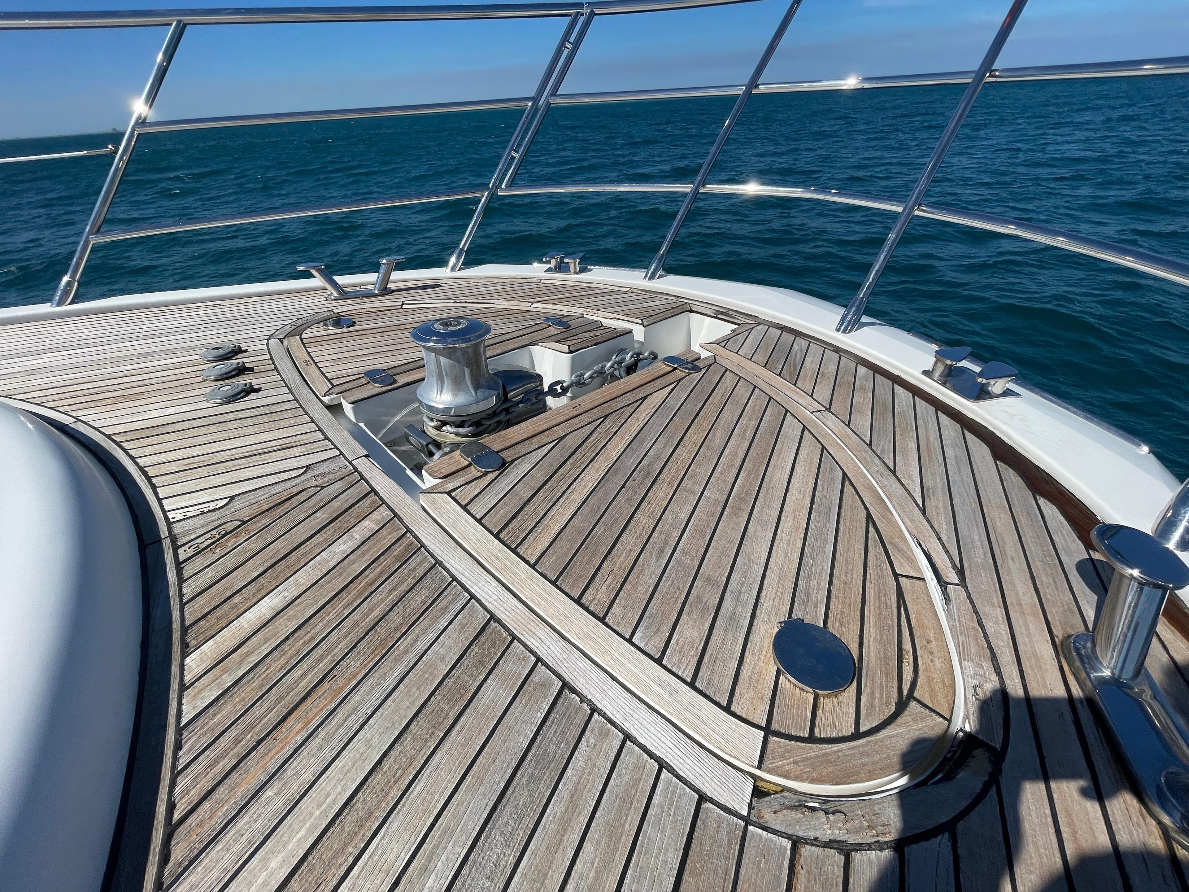 2014 Azimut 70 yacht deck with wooden finish, cruising on open water.