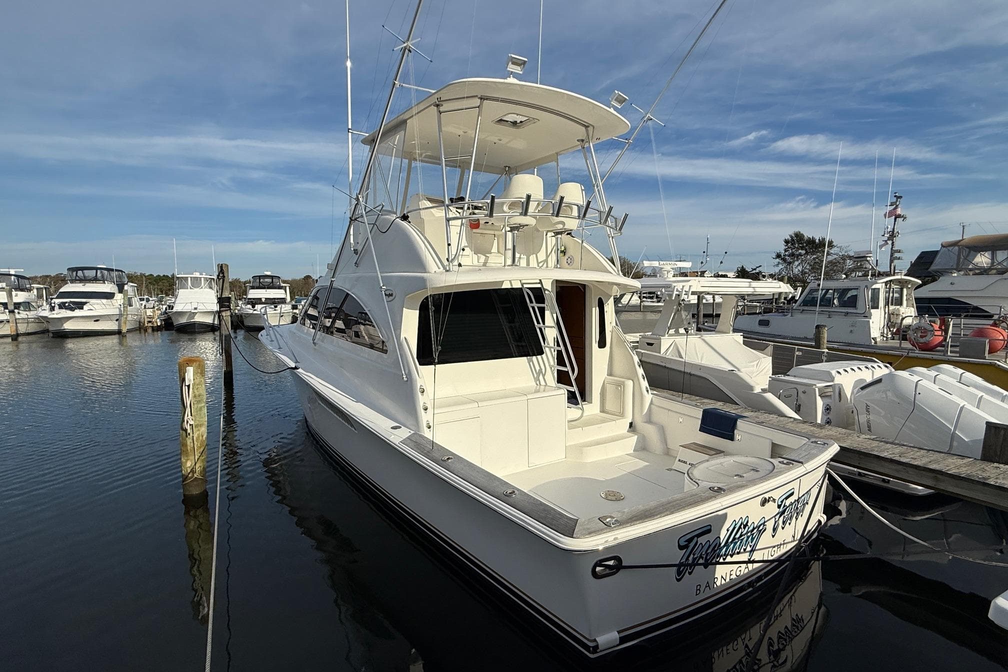 2005 Ocean Yachts 46 Super Sport docked at marina under clear sky.