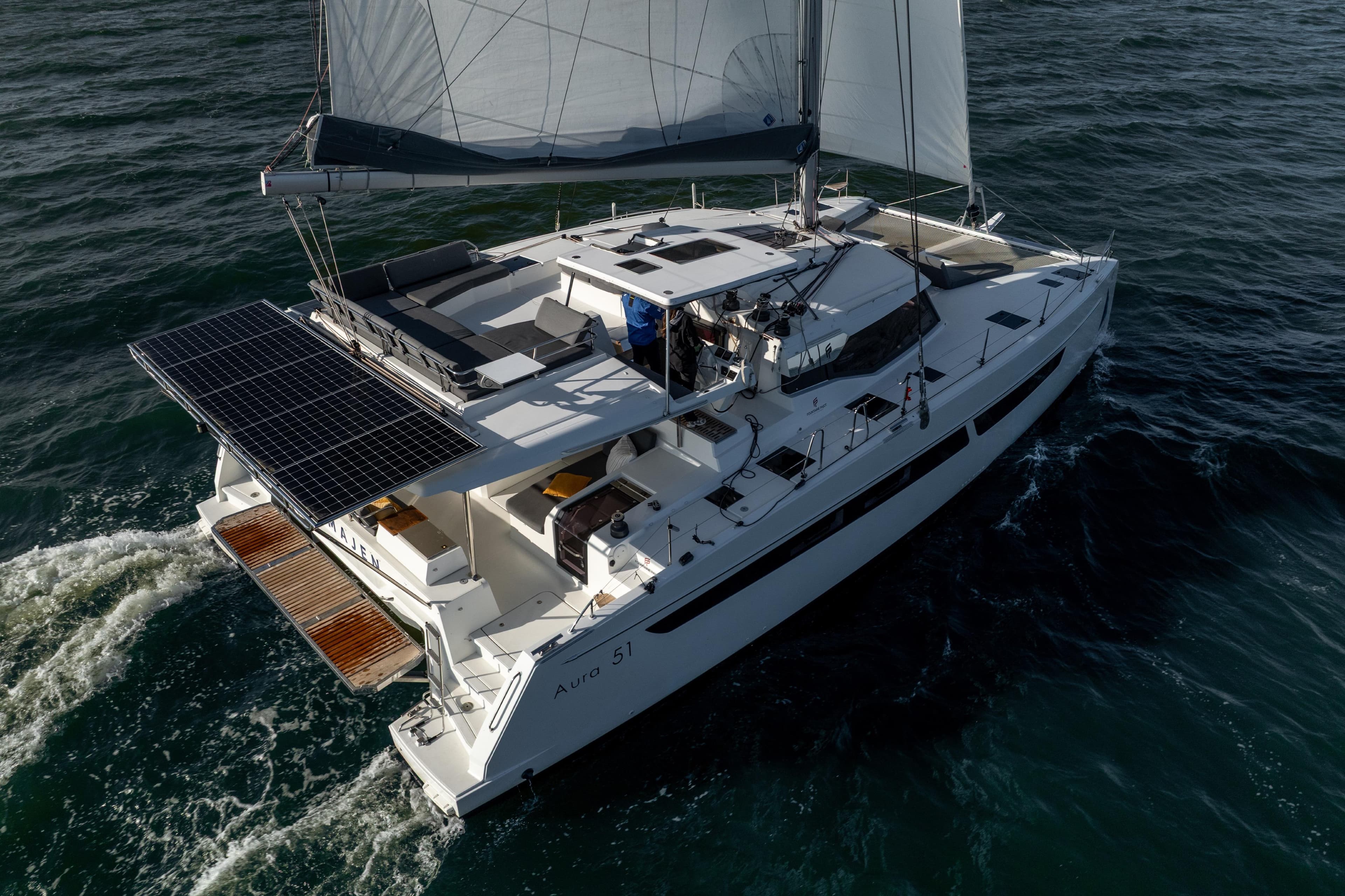 2022 Fountaine Pajot Aura 51 Catamaran sailing with solar panels on open water.