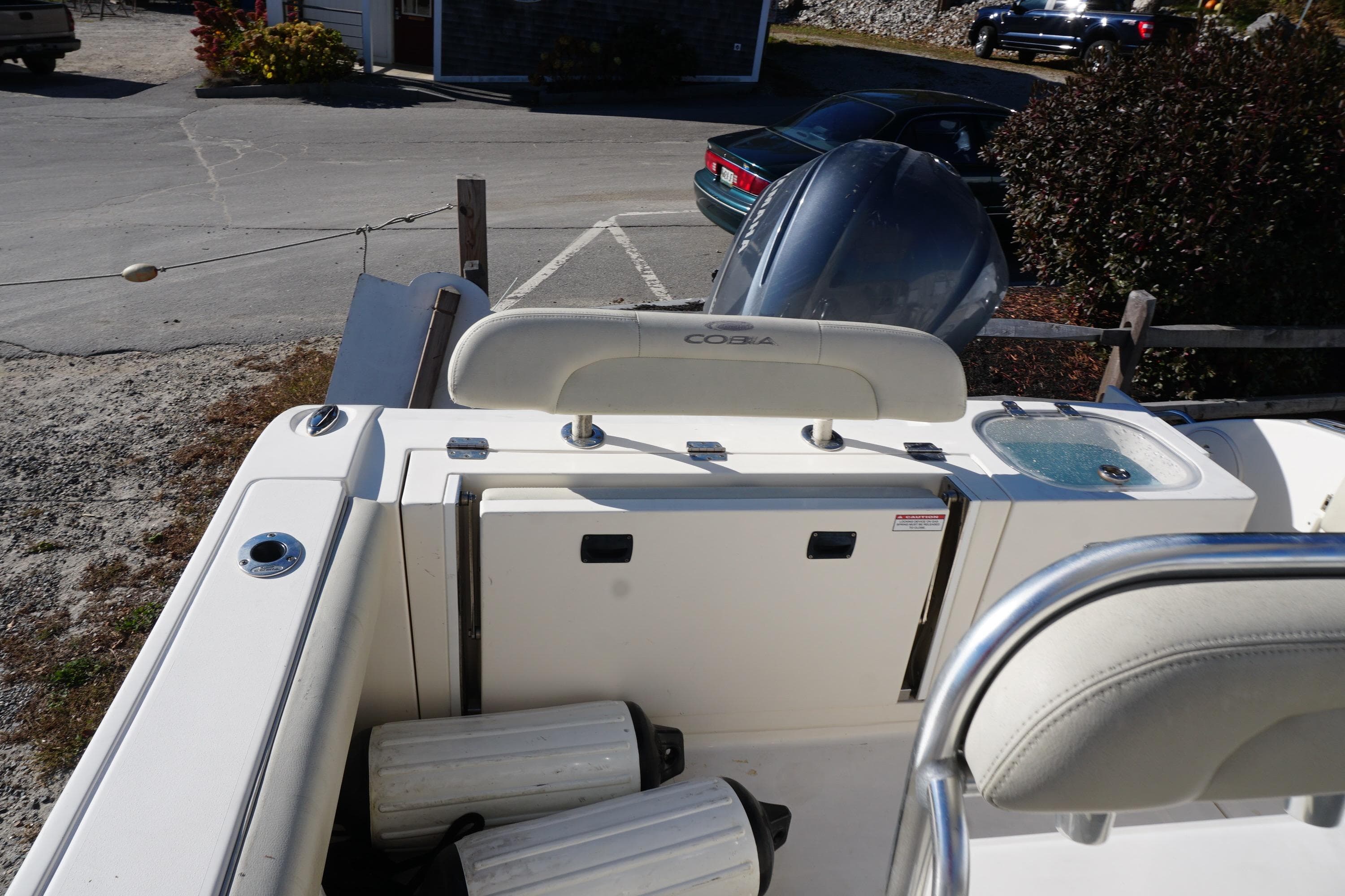 2019 Cobia 237 Center Console boat interior with seating and engine view.