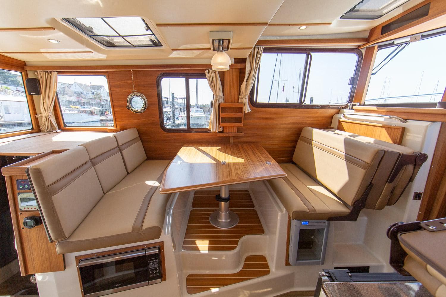 Manufacturer Provided Image: 2025 Ranger Tugs R-31 CB interior with wood accents and spacious seating area.