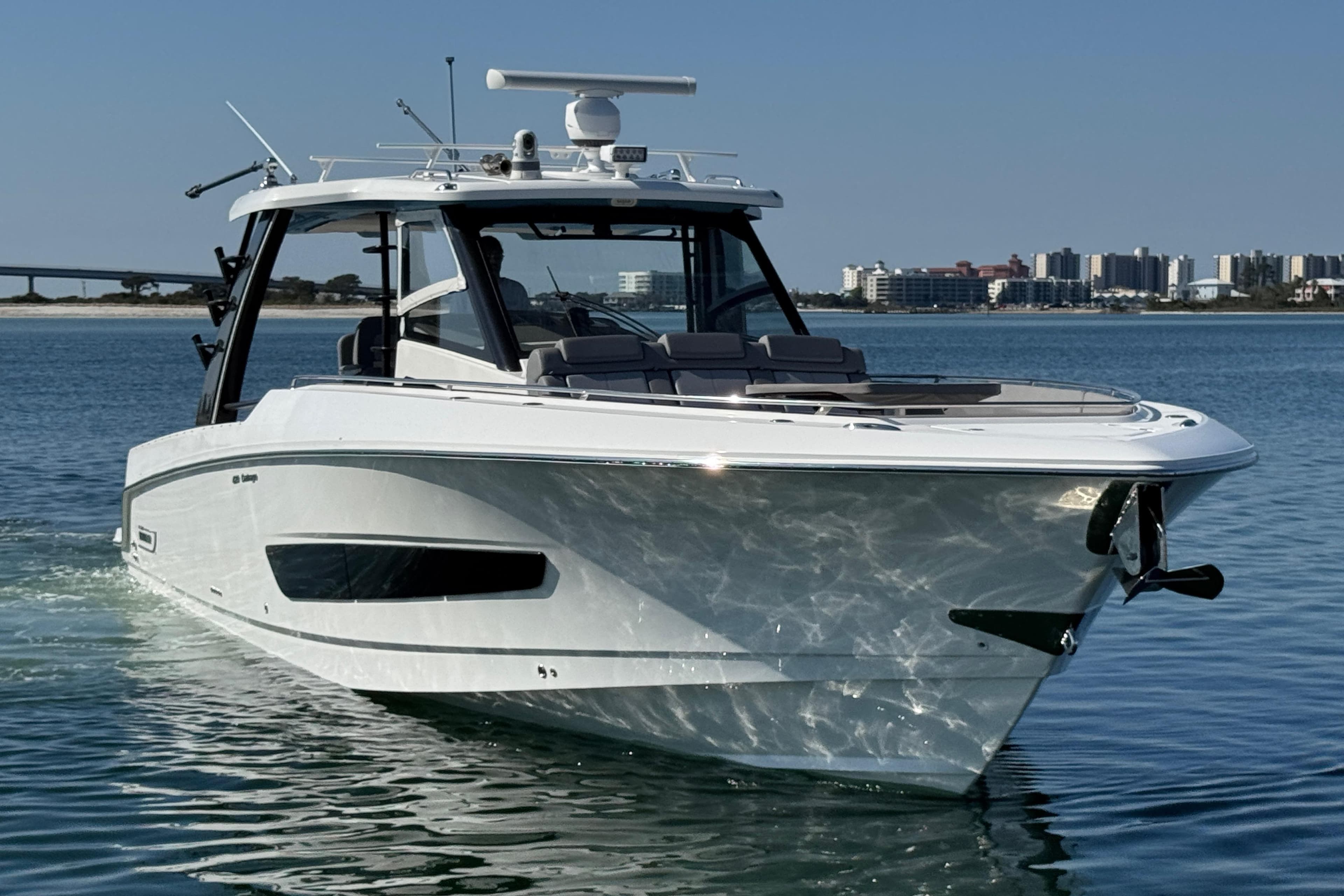 2021 Boston Whaler 420 Outrage boat on calm water with city skyline.