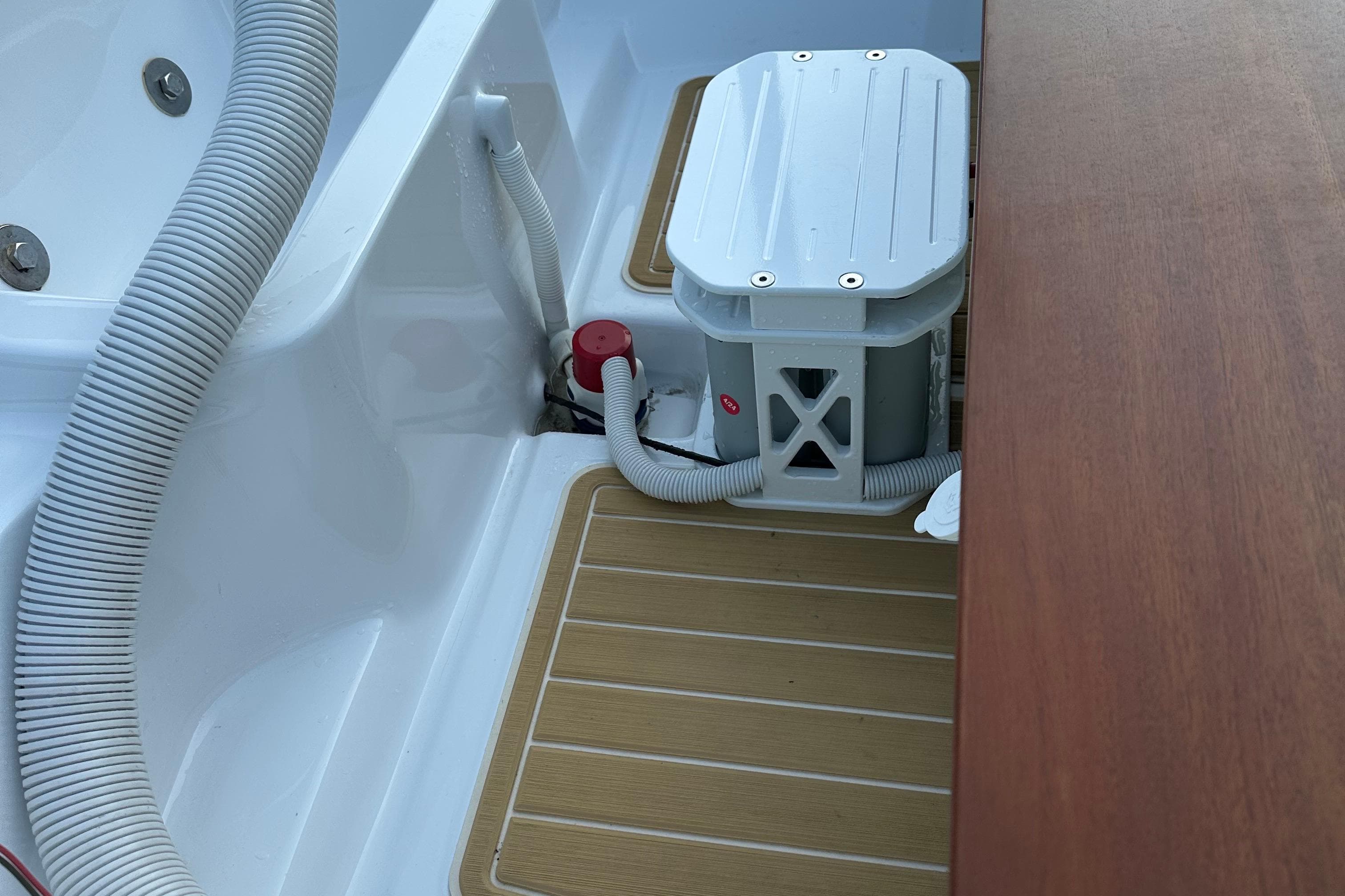 1981 Boston Whaler 13 Super Sport interior with hoses and storage compartment.