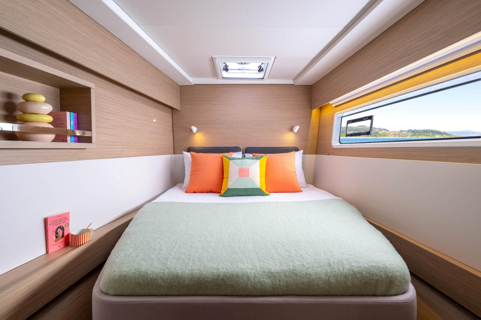 Manufacturer Provided Image: Luxurious cabin interior of 2025 Lagoon 43 yacht with modern decor and scenic window view.
