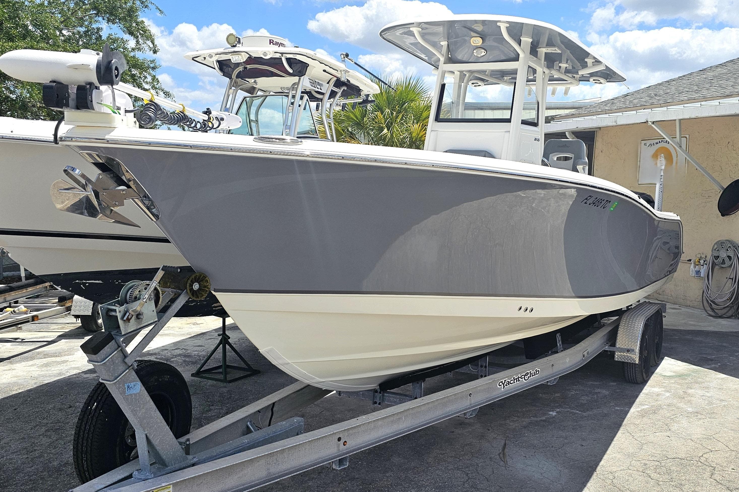 2022 NauticStar 28 XS boat on trailer, parked outdoors under a sunny sky.