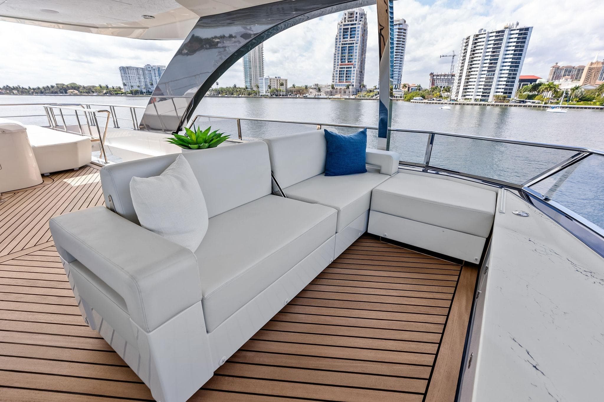 Luxurious seating on 2024 Ocean Alexander 35 Revolution yacht, with waterfront cityscape view.