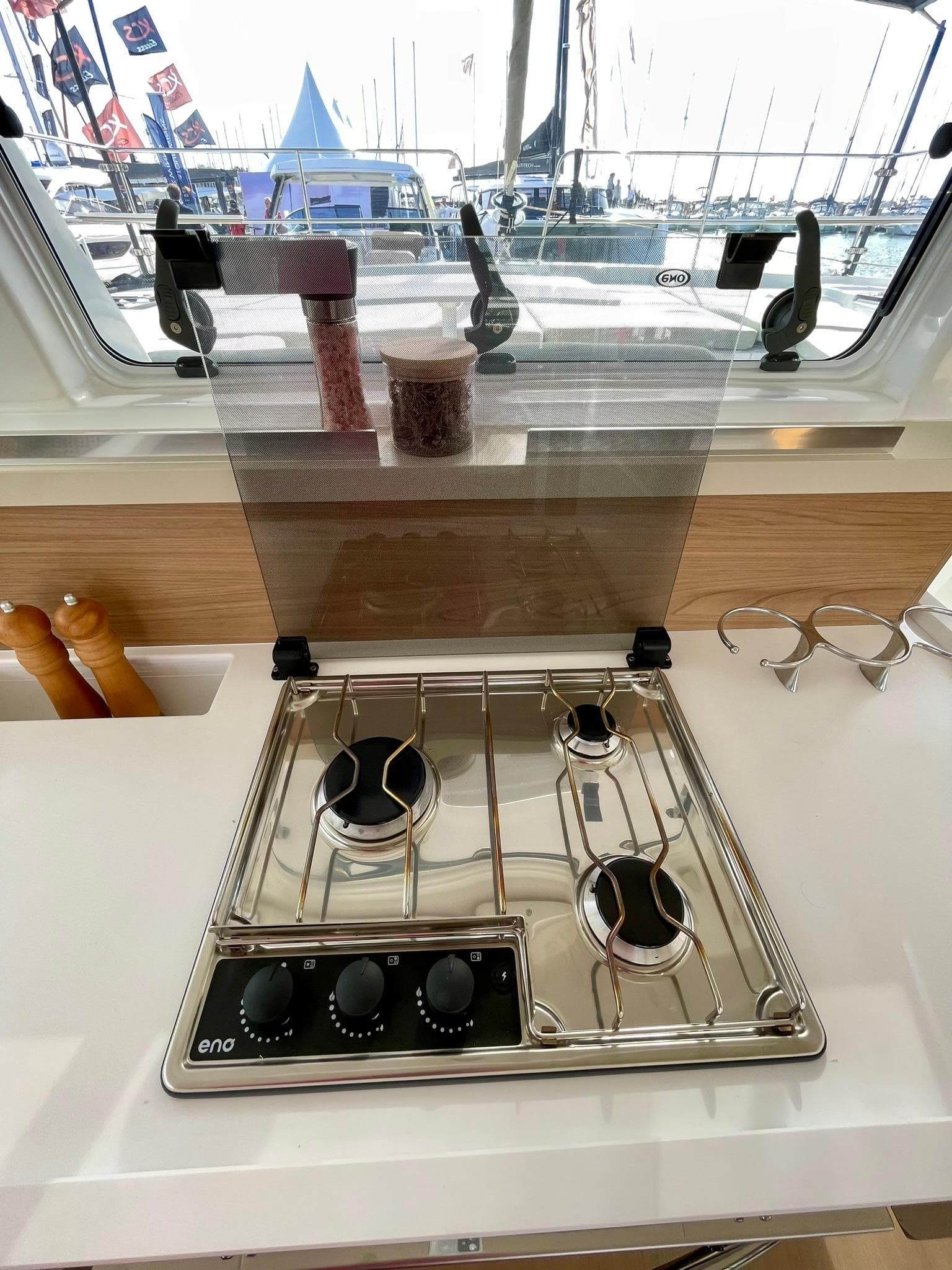 Modern kitchen stove on Bali 4.2 yacht, 2026 model, with three burners and control knobs.