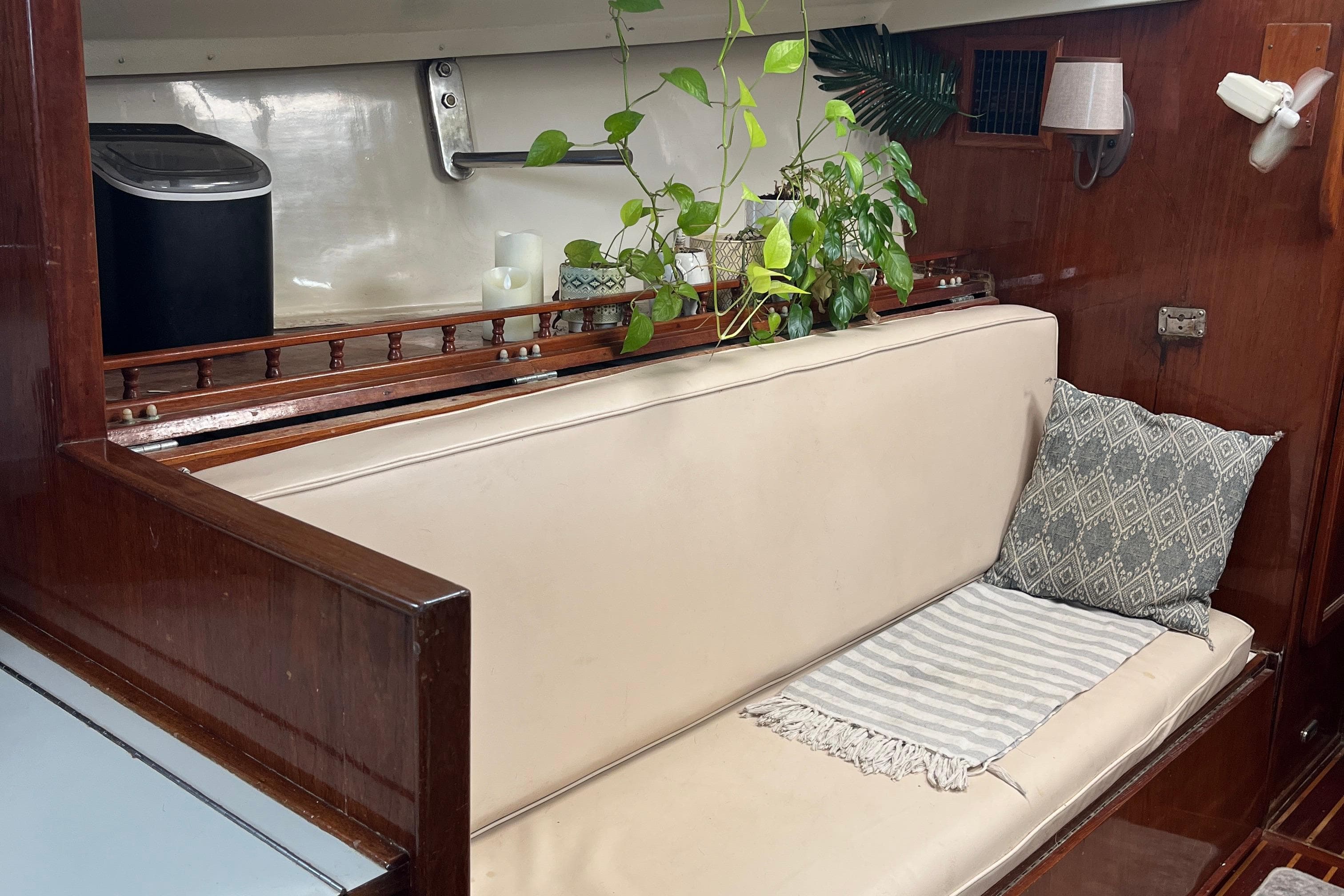 1982 Morgan 462 yacht interior with beige seating, decorative plants, and wooden accents.