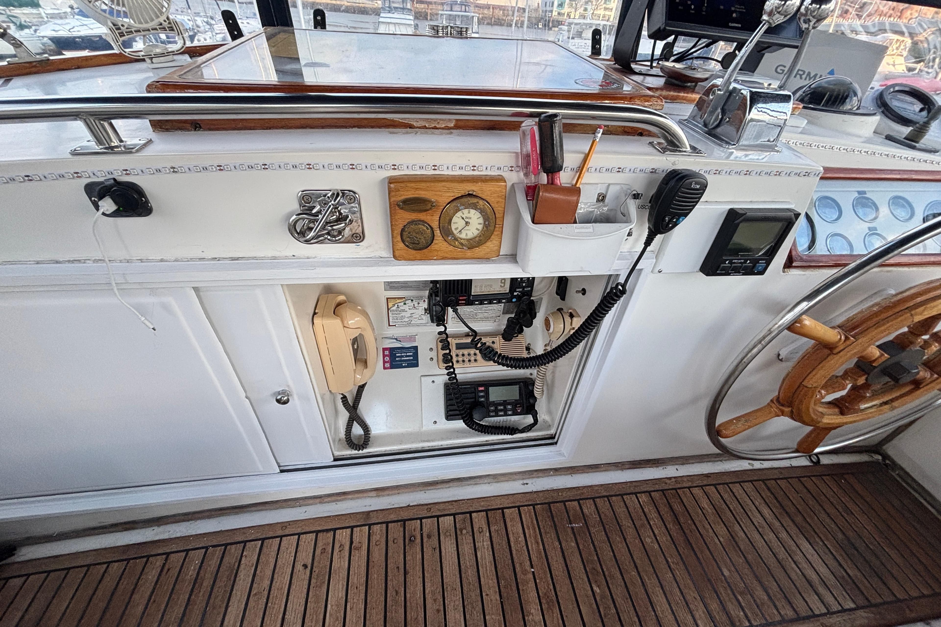 1987 Grand Banks 42 Classic helm with navigation instruments and wooden steering wheel.