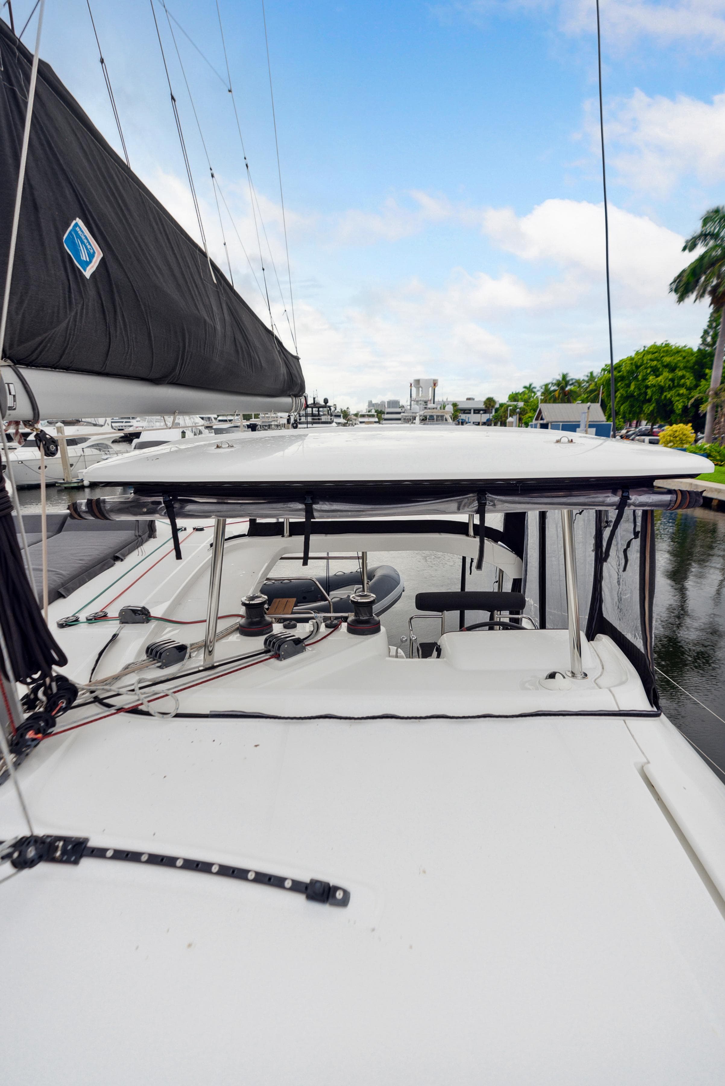 2019 Lagoon 42 catamaran deck view with sails and water backdrop.