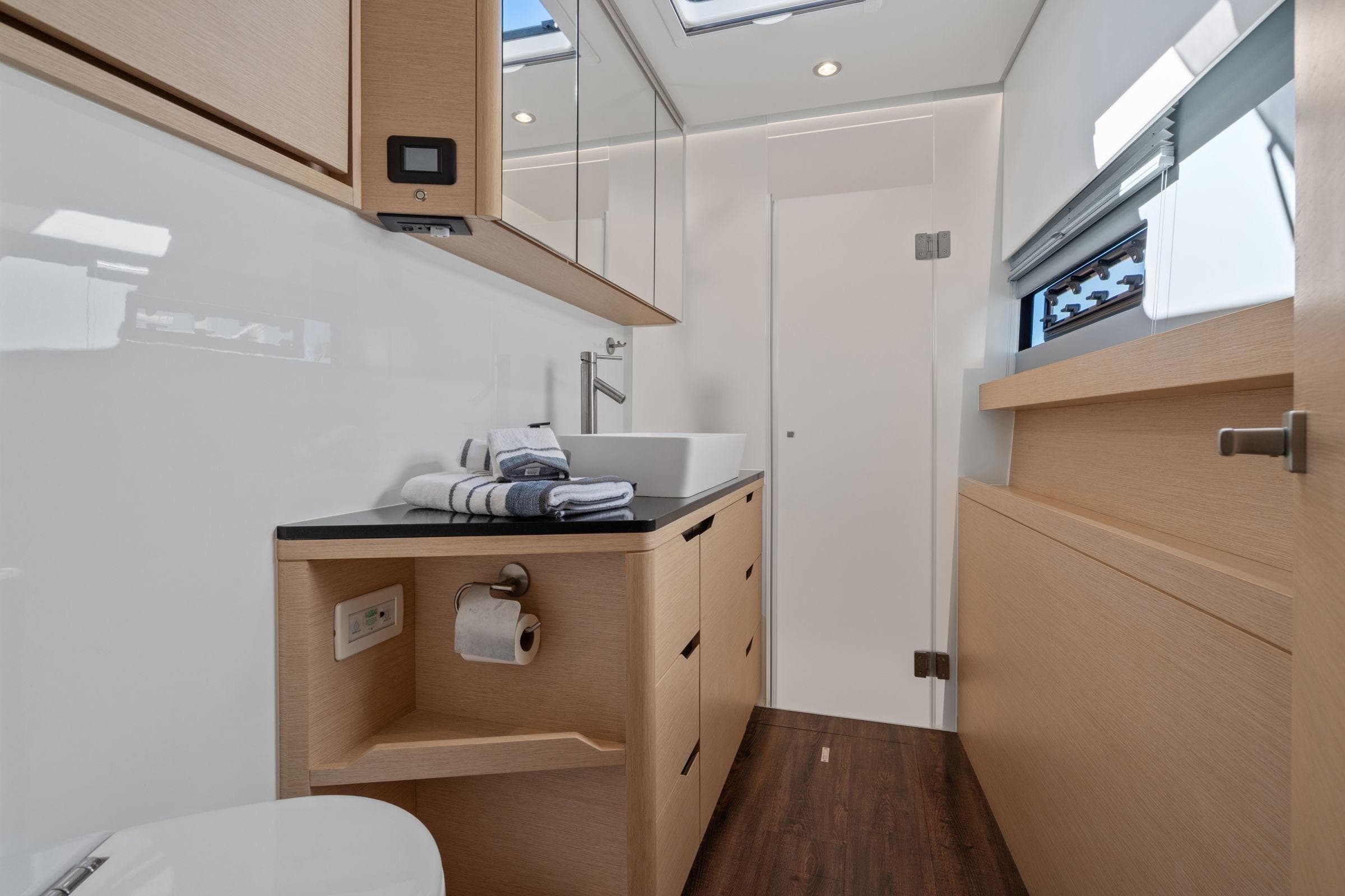 Luxurious bathroom interior of 2019 Itacatamarans 14.99, featuring modern fixtures and elegant design.