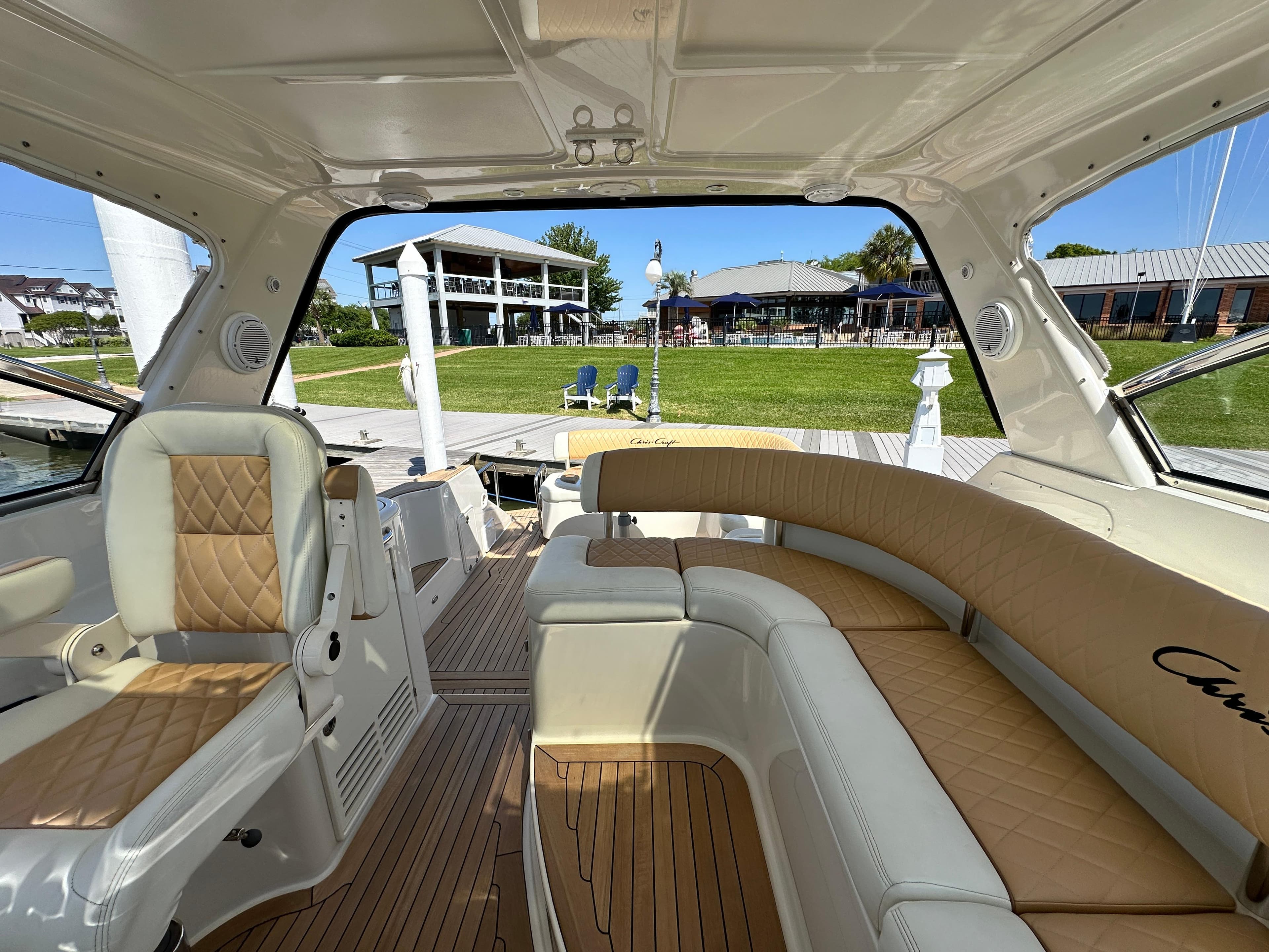 Luxurious interior of 2007 Chris-Craft Roamer 40 yacht with elegant seating and scenic marina view.