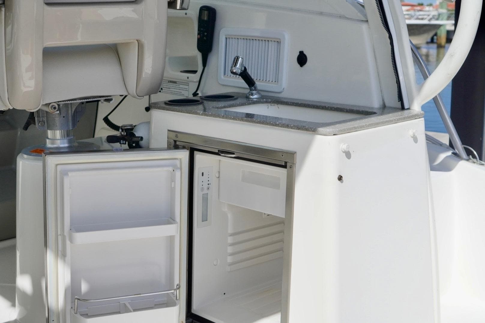 2015 Boston Whaler 315 Conquest boat interior with open fridge and sink.