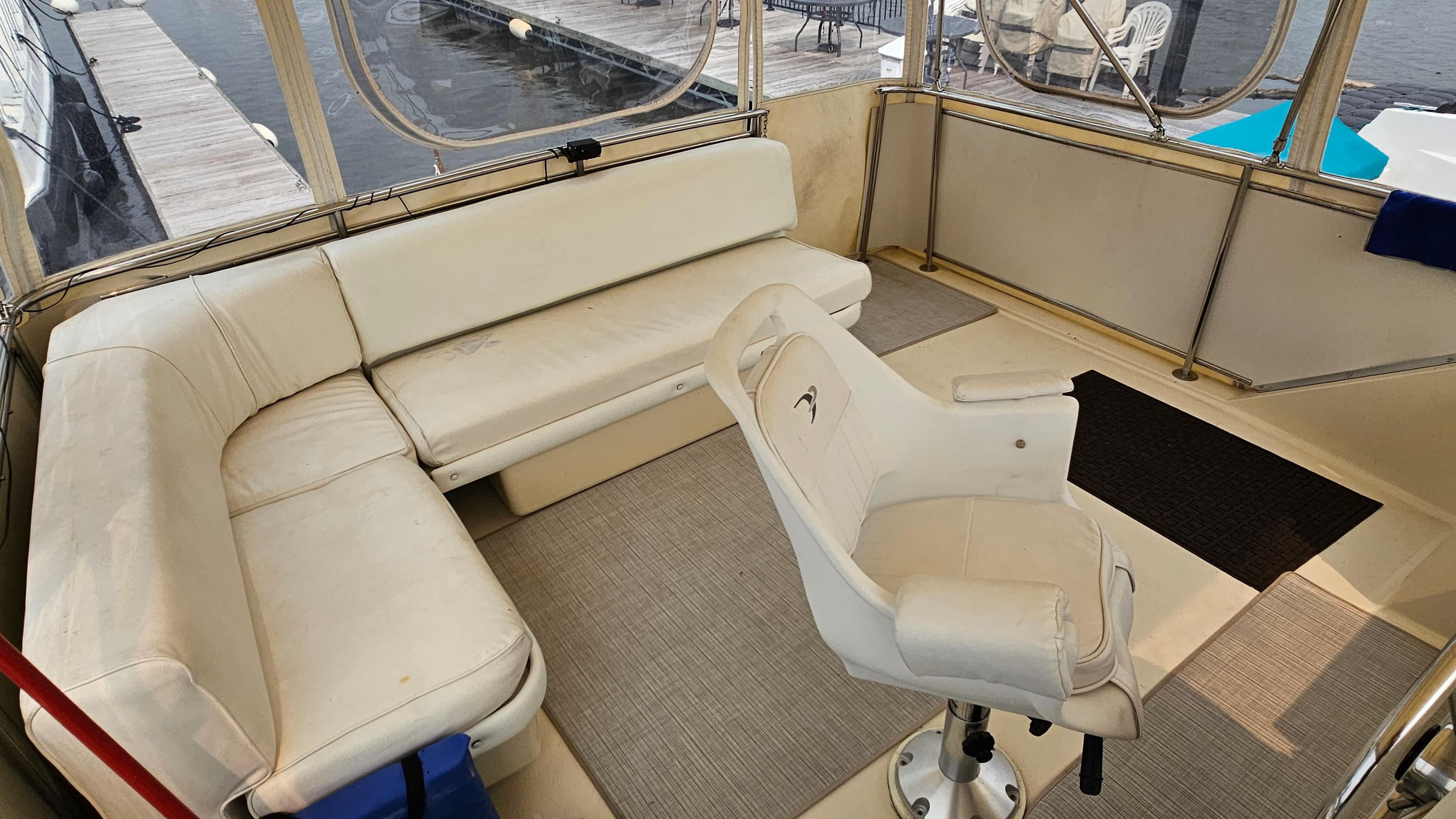 1986 Chris-Craft 381 Catalina interior with white seating and captain's chair.