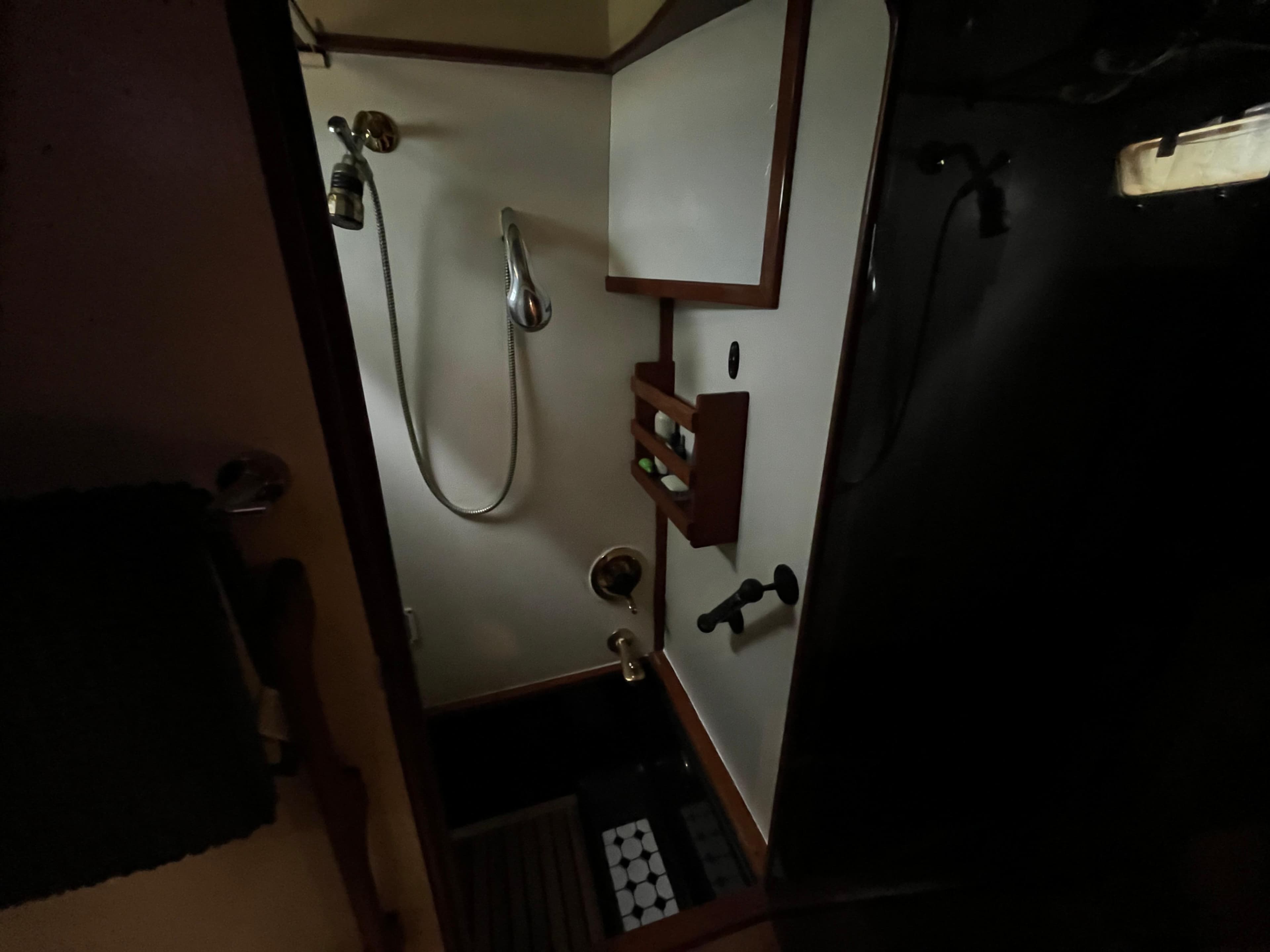 Shower area inside 1990 Antigua 58 Pilothouse yacht, featuring wooden accents and nautical design.