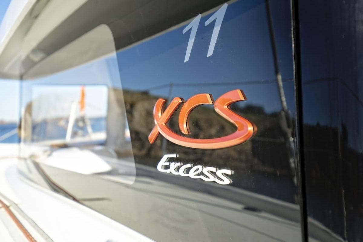 2026 Excess 11 yacht with sleek design and reflective surface, featuring XCS branding.