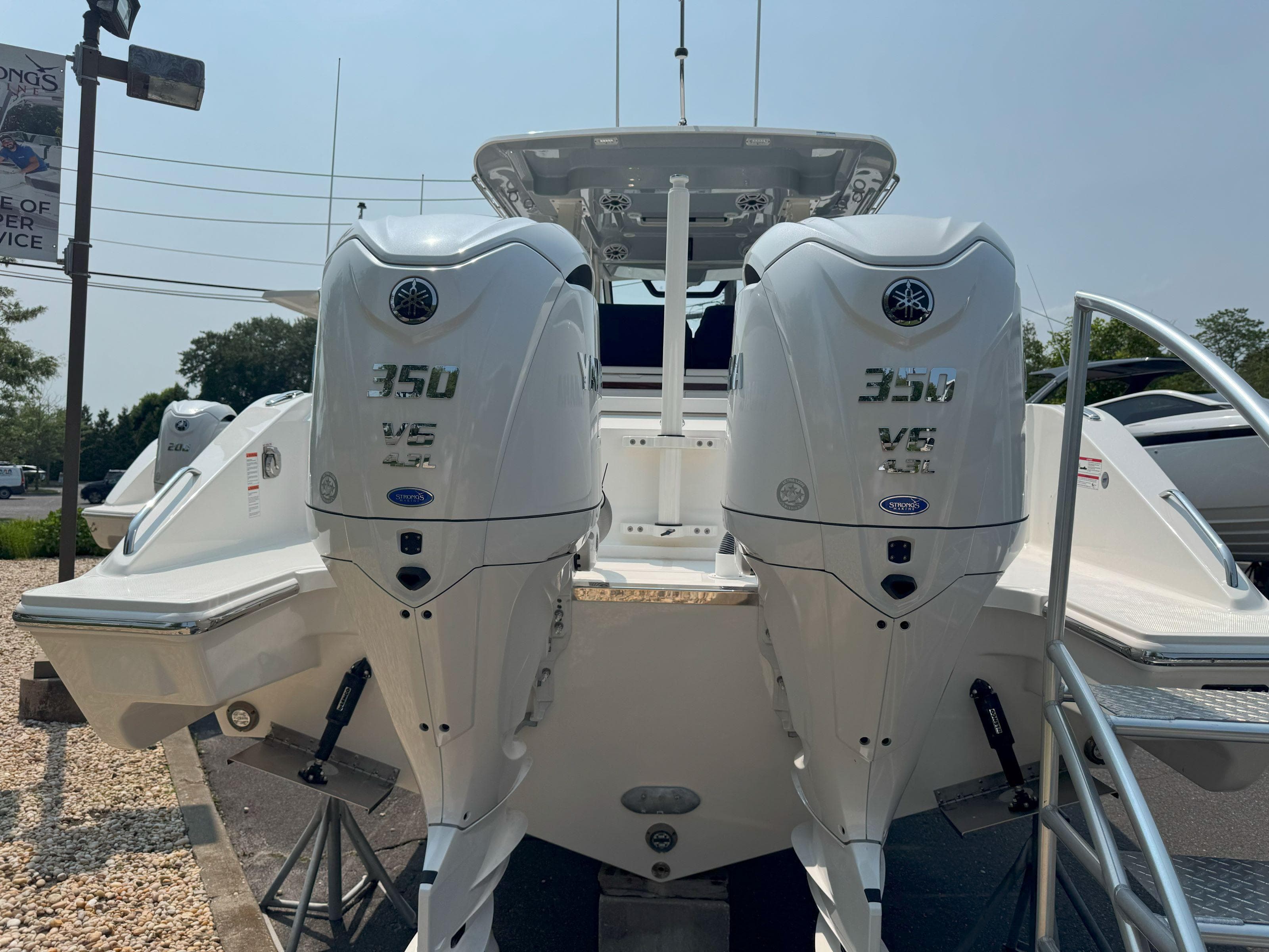 2025 Pursuit S 328 boat with twin 350 V8 engines displayed outdoors.